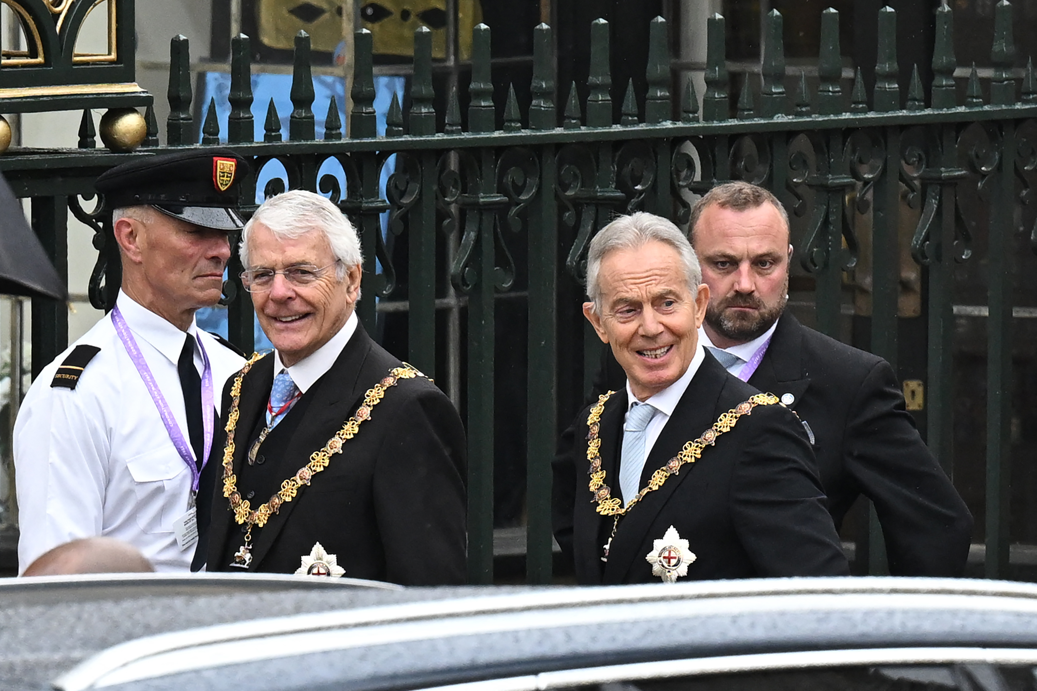 Former UK Prime Ministers John Major, left, and Tony Blair arrive at Westminster Abbey in London on Saturday, 