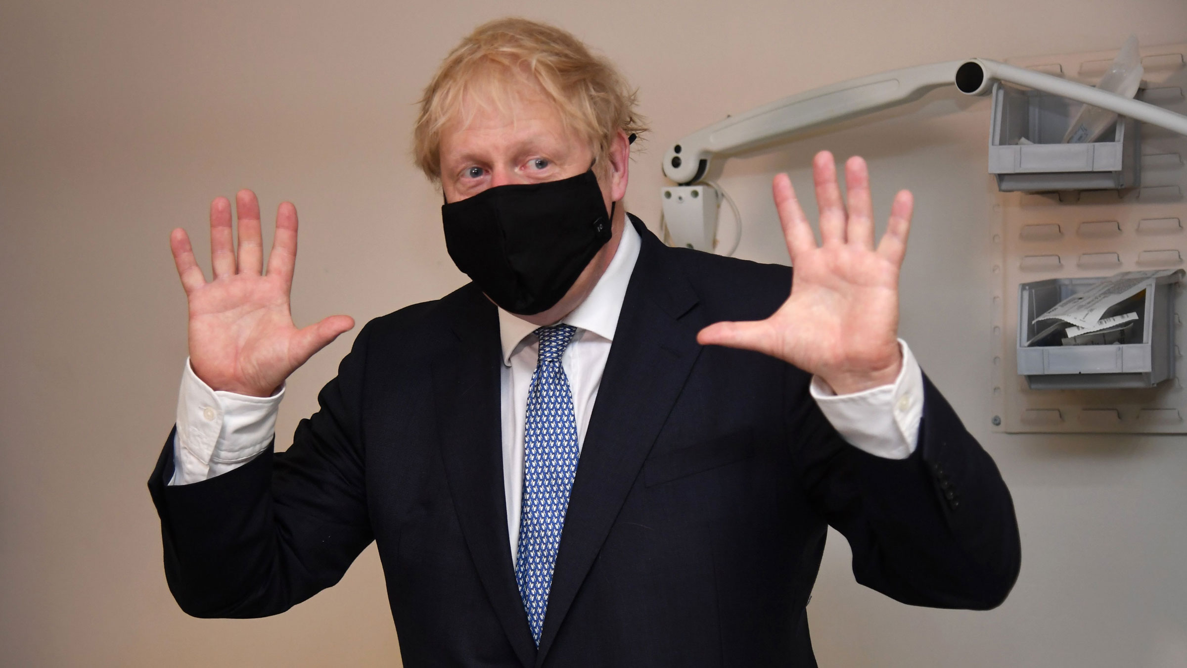 British Prime Minister Boris Johnson gestures during a visit to the Tollgate Medical Centre in London on Friday.
