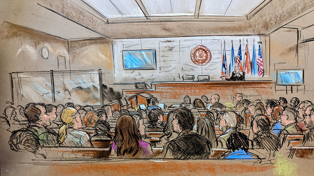 Members of the public are seen in the foreground, with Delaware Superior Court Judge Eric Davis on the far right.  On the left are smudged glass panels to obscure the jurors and protect their identity. 