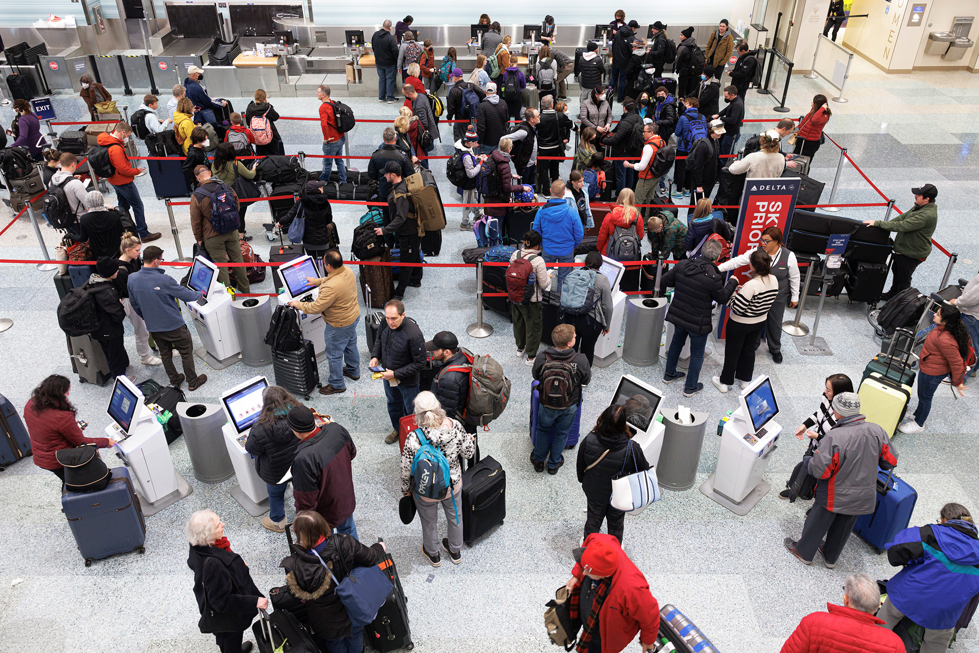 Travelers wait to check in for their flights at Minneapolis−Saint Paul International Airport on December 22. 