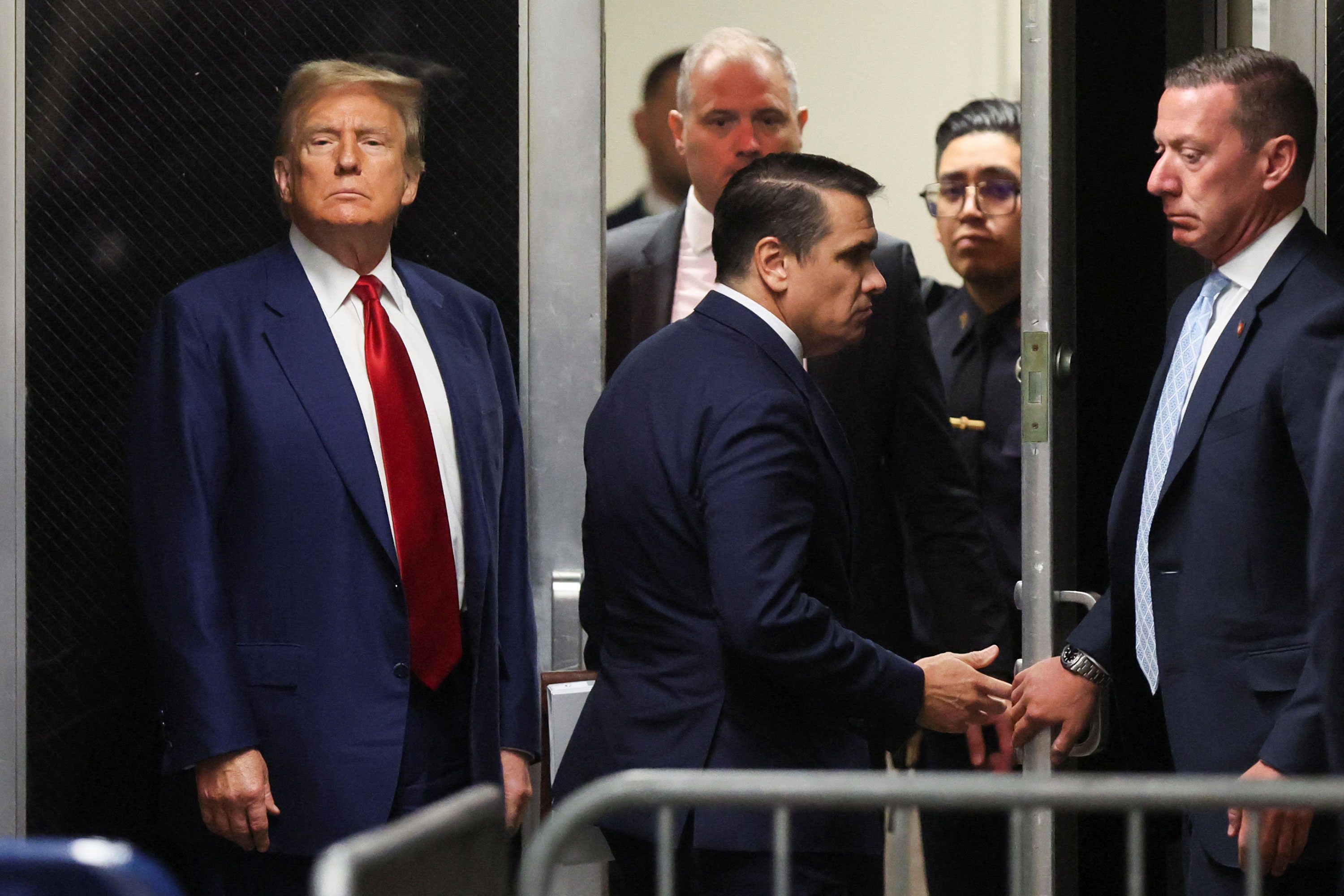 Former President Donald Trump turns toward the press outside a courtroom in New York on Monday.
