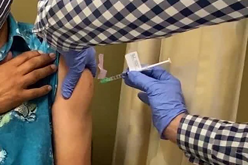 A man receives an injection as UCLA and AstraZeneca begin phase 3 trials for a potential Covid-19 vaccine. 
