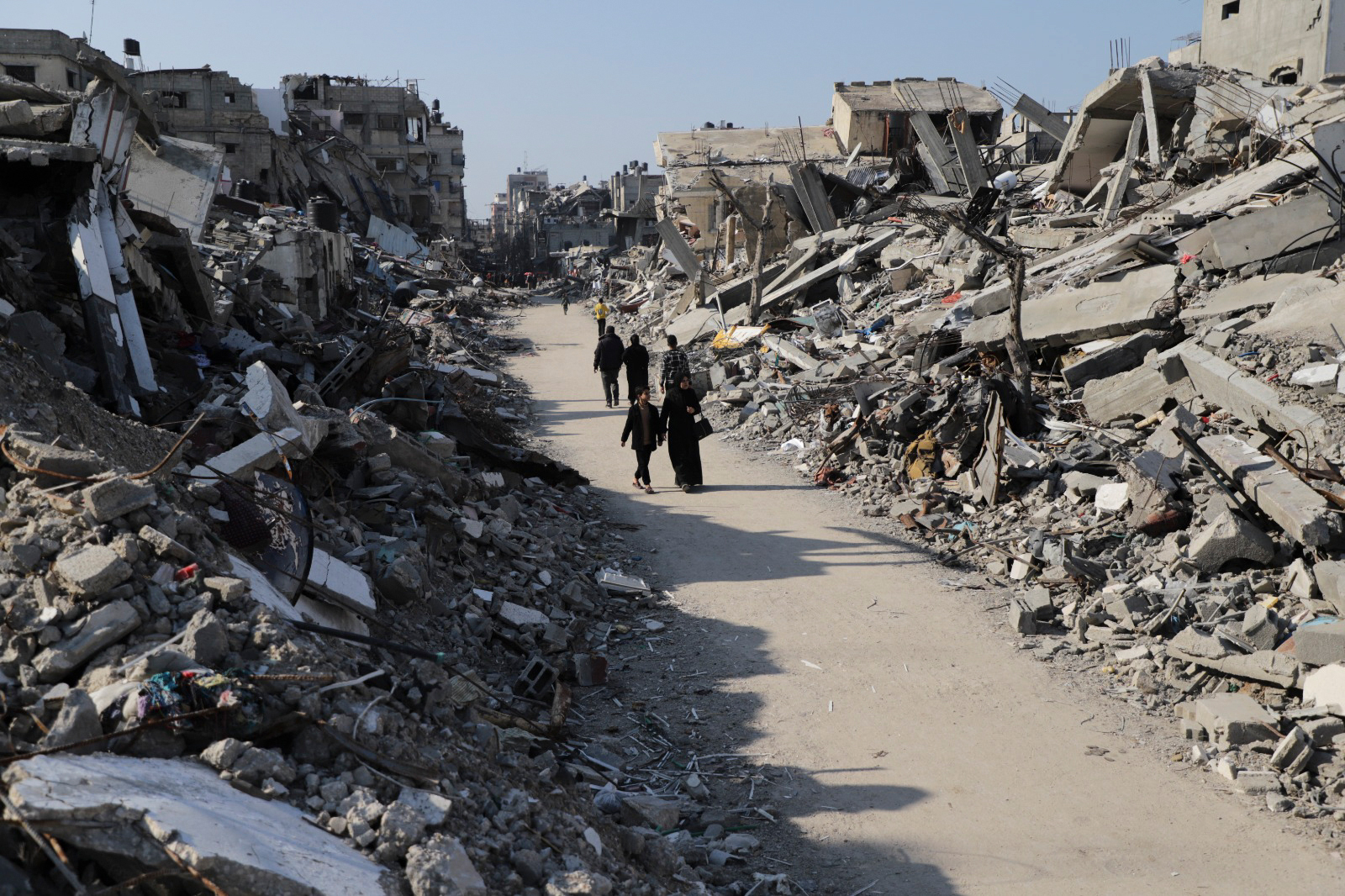 People walk through destruction in the Jabalya refugee camp in Gaza, on February 29. 