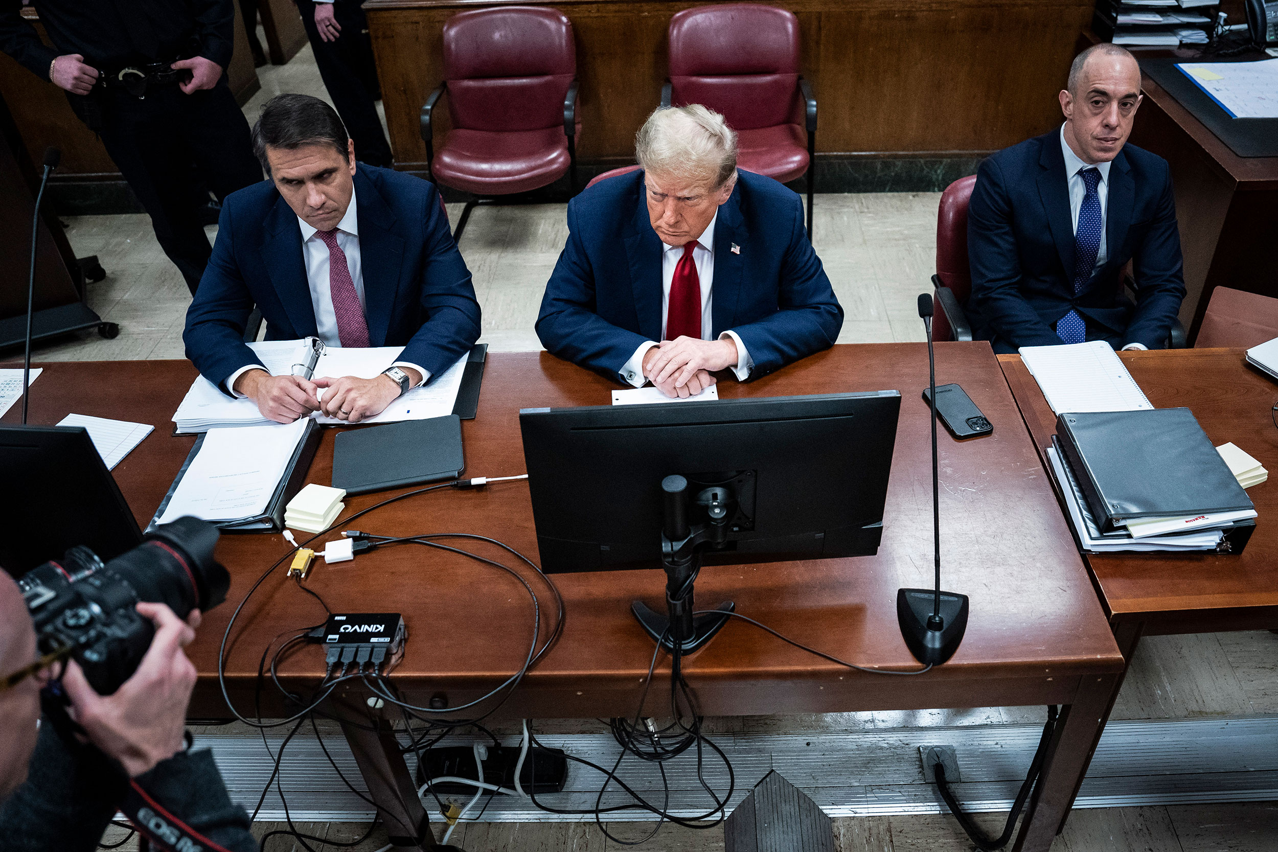 Former President Donald Trump appears in court with his attorneys Todd Blanche, left, and Emil Bove on April 15.