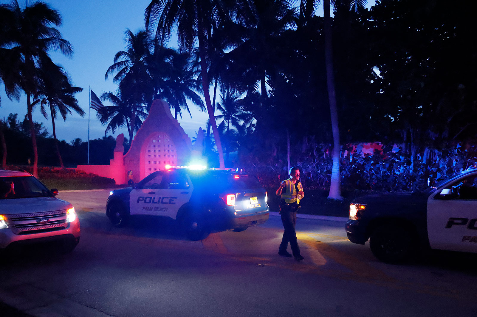 Police direct traffic outside an entrance to former President Donald Trump's Mar-a-Lago estate on Aug.