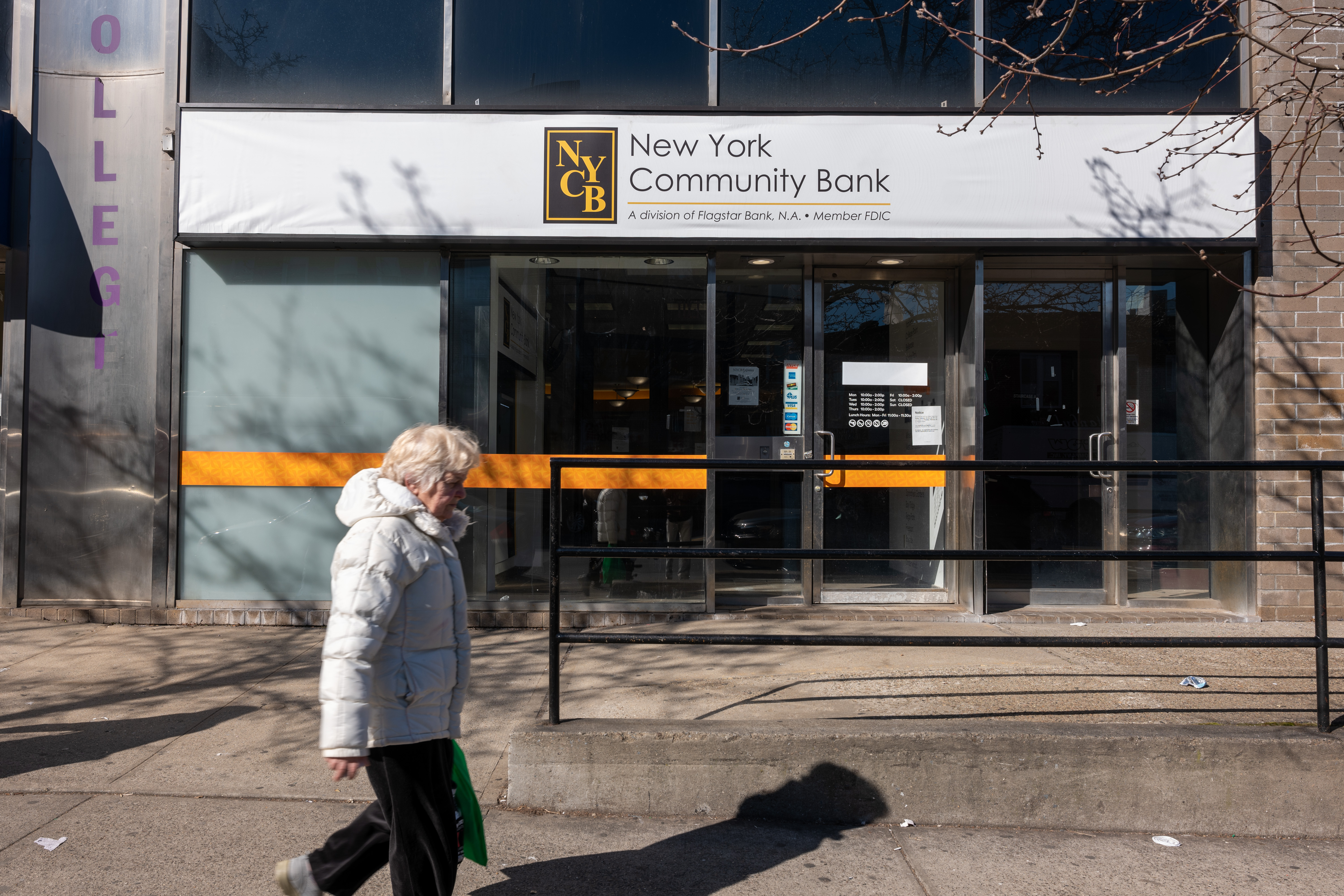 A person walks by a New York Community Bank in Brooklyn, New York, on February 8.