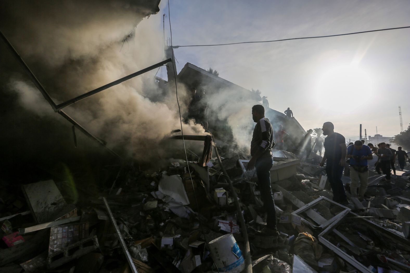 People search through destroyed buildings during Israeli air raids in Khan Younis, Gaza on November 7.