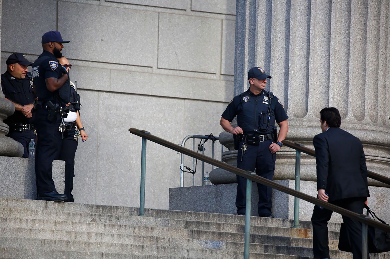 Police keep watch outside the court on Tuesday.