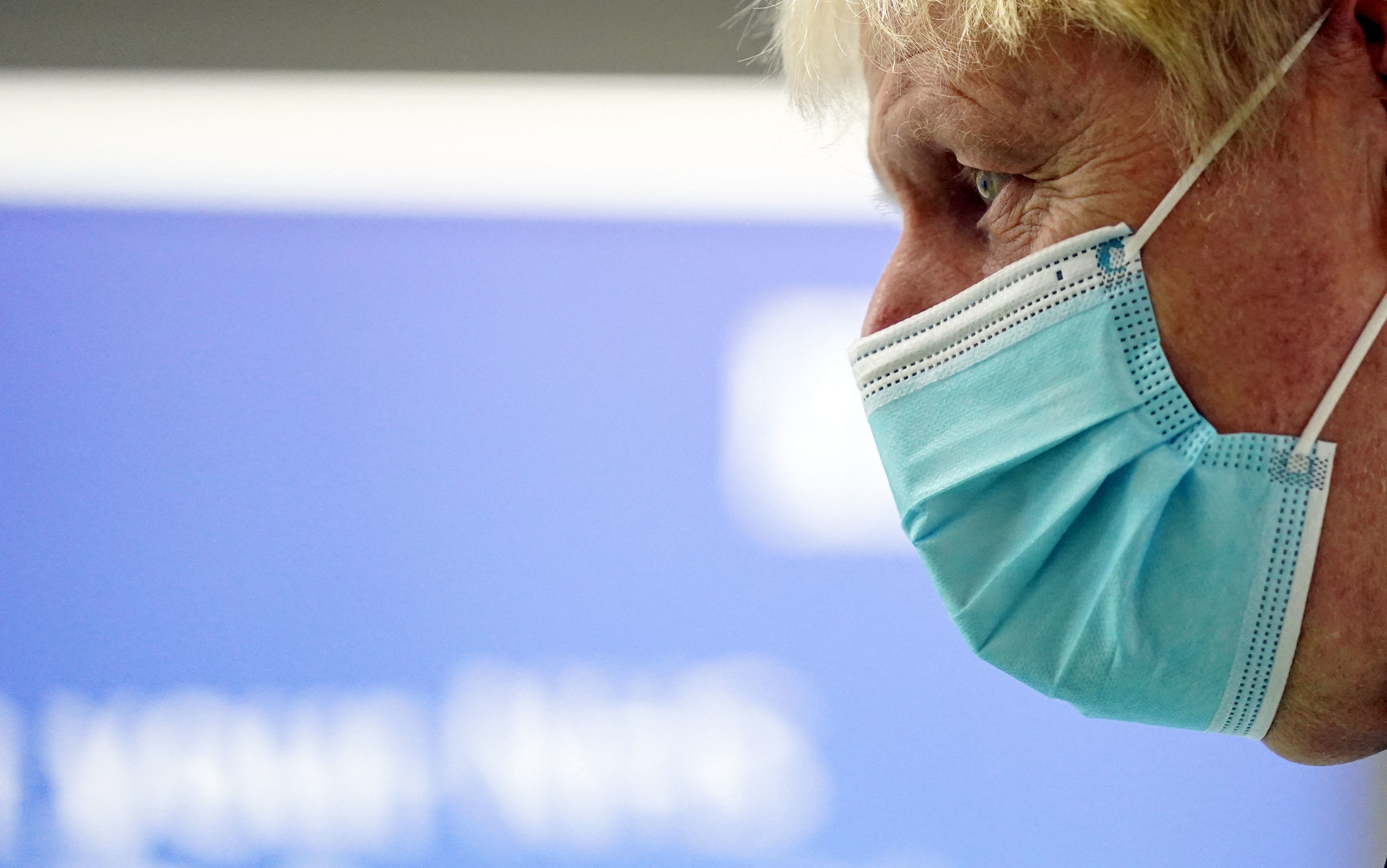 Prime Minister Boris Johnson, wearing a face covering to mitigate the spread of coronavirus, reacts during his visit to a Covid-19 vaccination hub in the Guttman Centre at Stoke Mandeville Stadium in Aylesbury, north west of London on January 3, 2022.