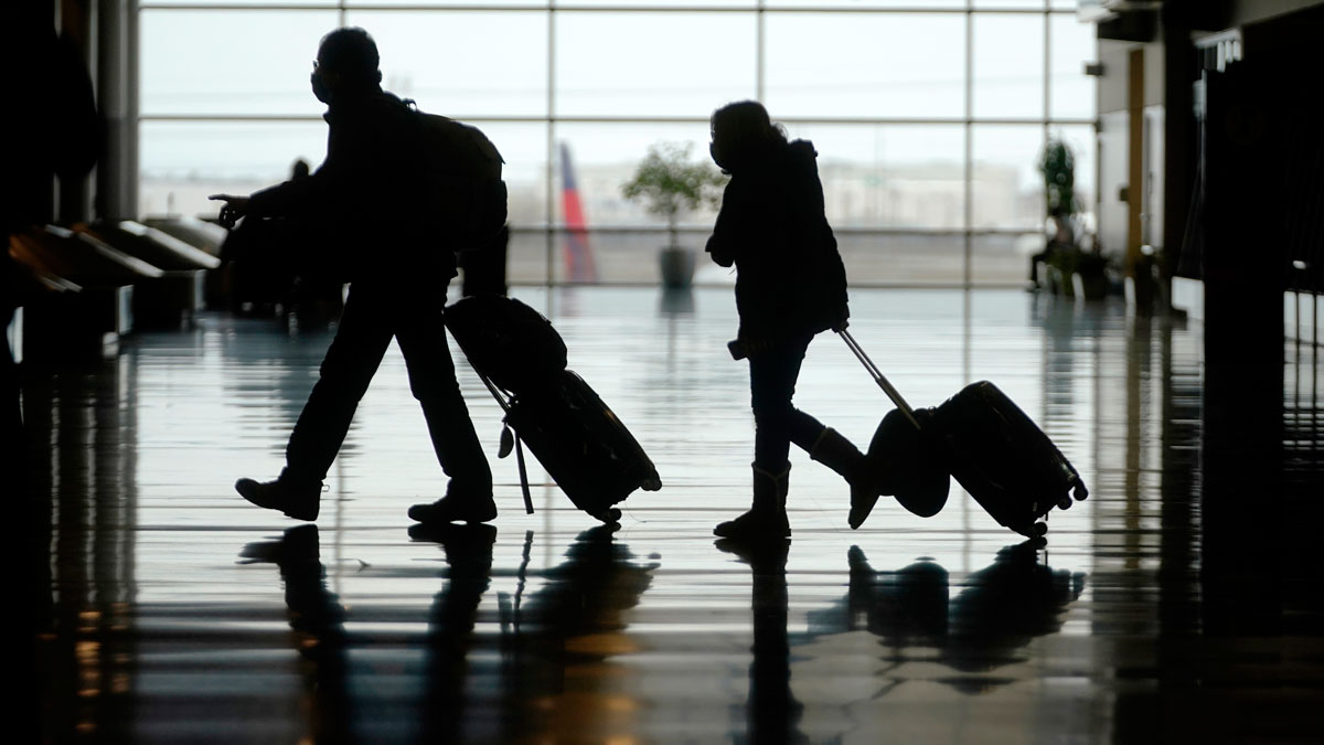 Travelers walk through the Salt Lake City International Airport on March 9.