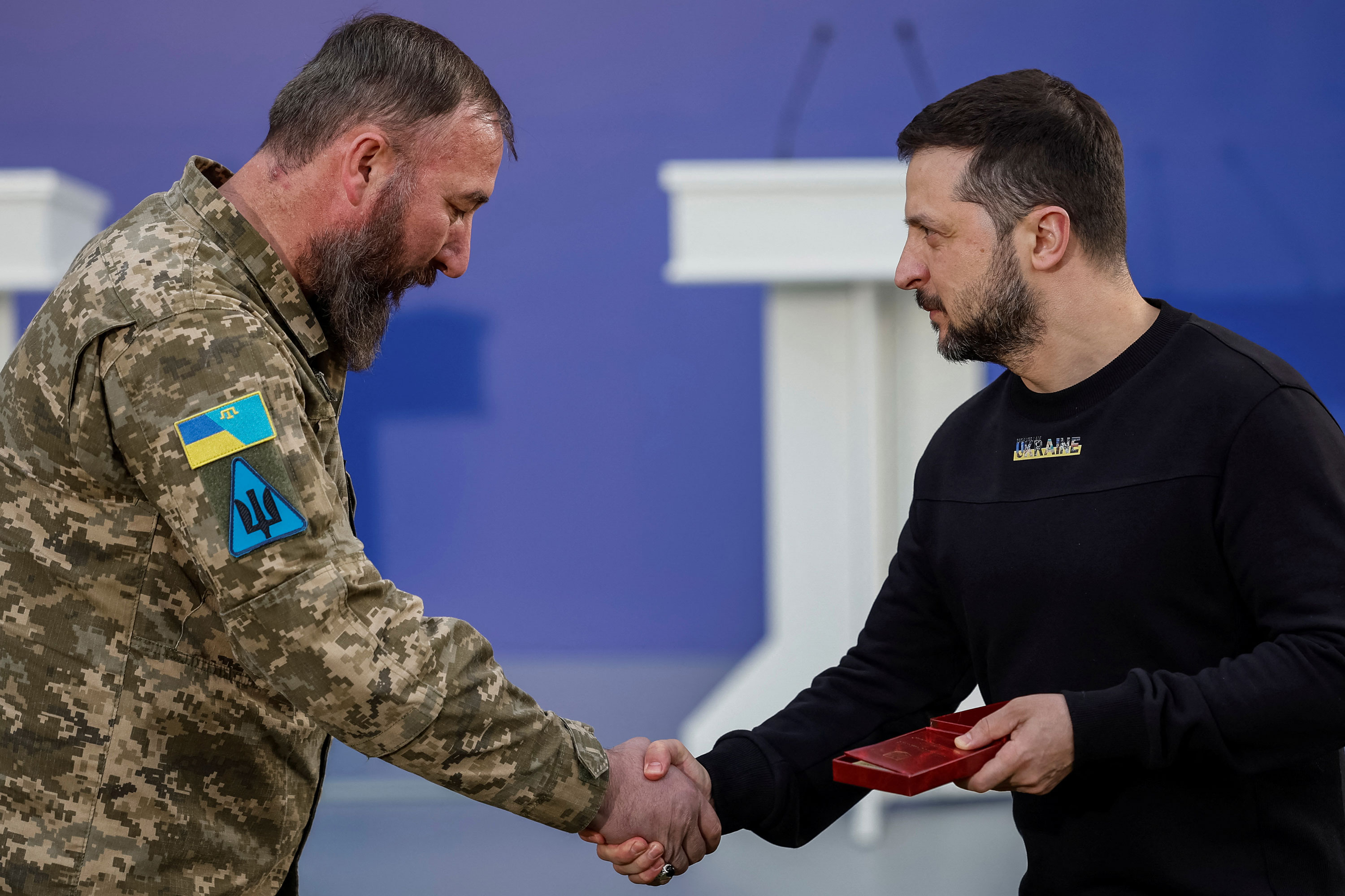 Ukrainian President Volodymyr Zelensky honors Muslim soldier Ilimdar Khodzhametov with The "Defender of the Motherland" medal before sharing Iftar with Ukrainian Muslim soldiers in a front of a mosque in the outskirts of Kyiv on April 7. 