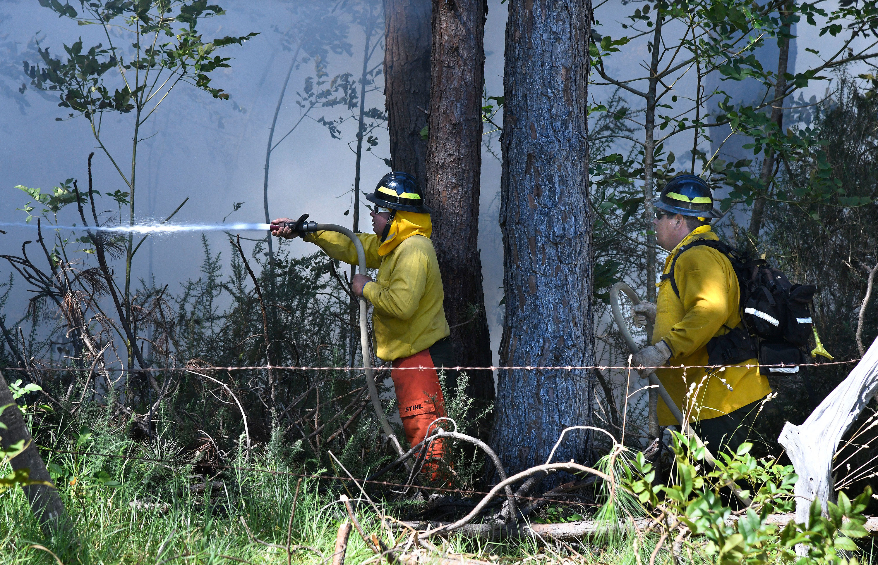Members of a Hawaii Department of Land and Natural Resources wildland firefighting crew on Maui battle a fire in Kula, Hawaii on August 8.