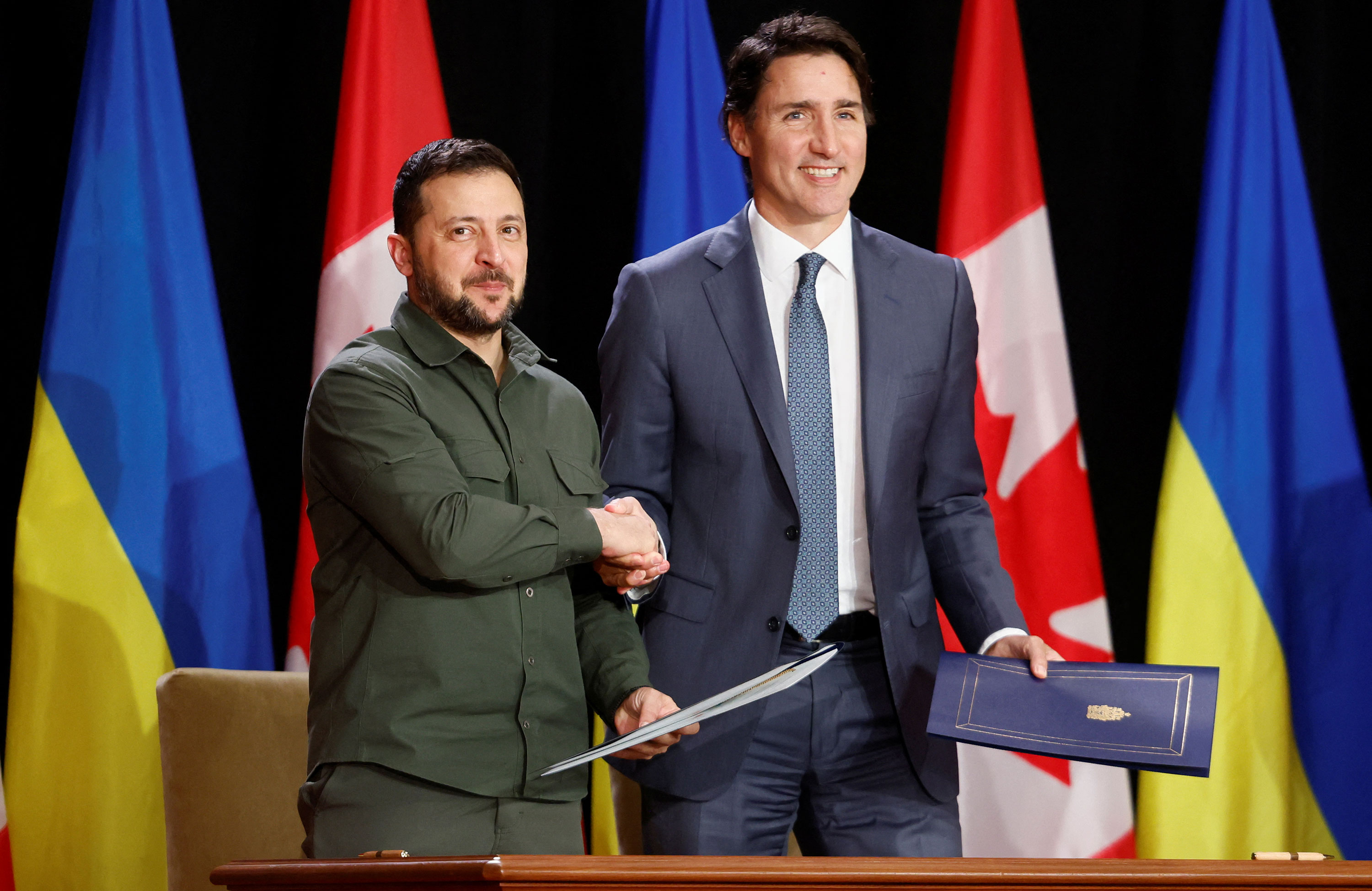 Ukrainian President Volodymyr Zelensky shakes hands with Canadian Prime Minister Justin Trudeau after signing a Free Trade Agreement in Ottawa on Friday, September 22, 2023. 