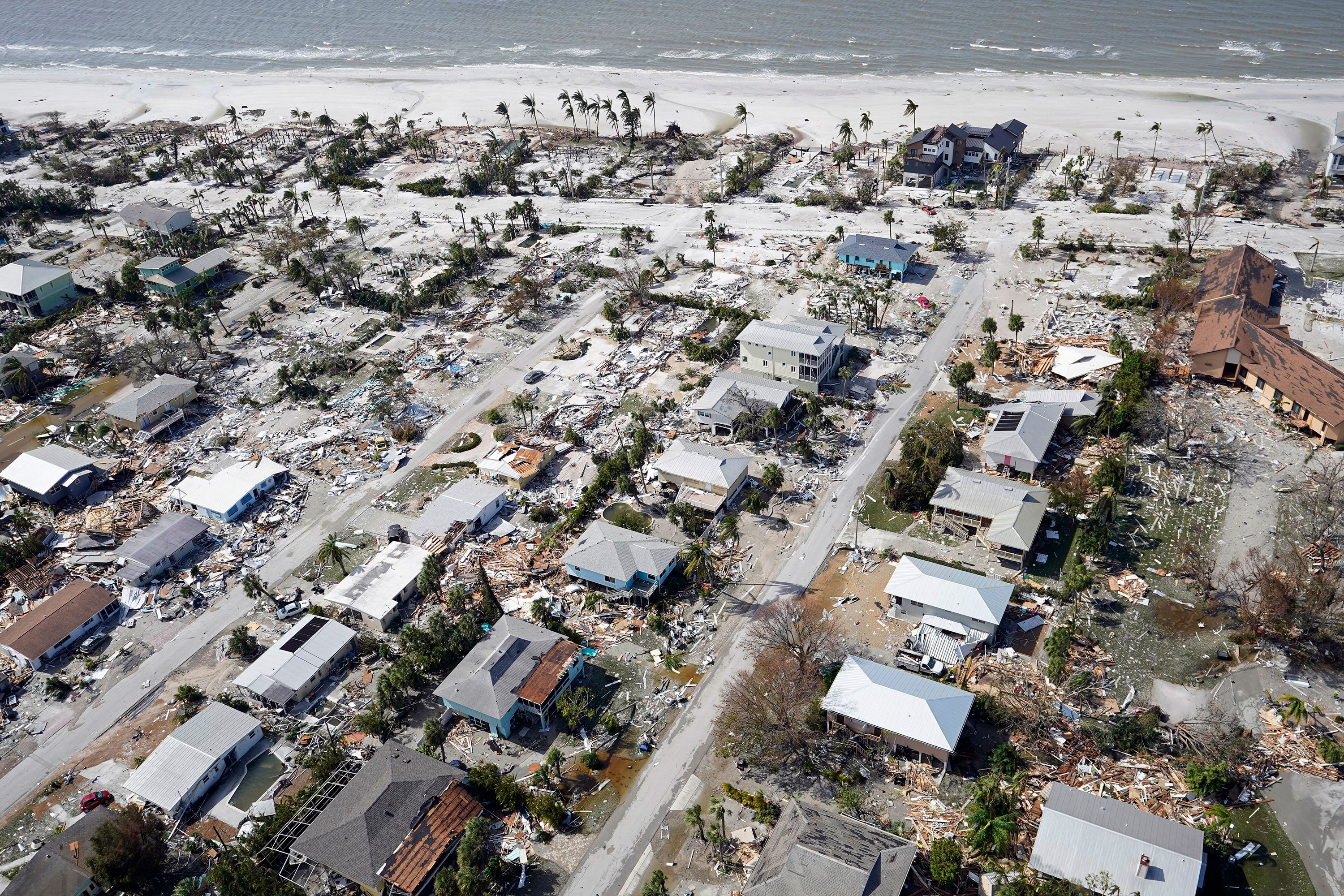 Debris lies among damaged homes in Fort Myers Beach.