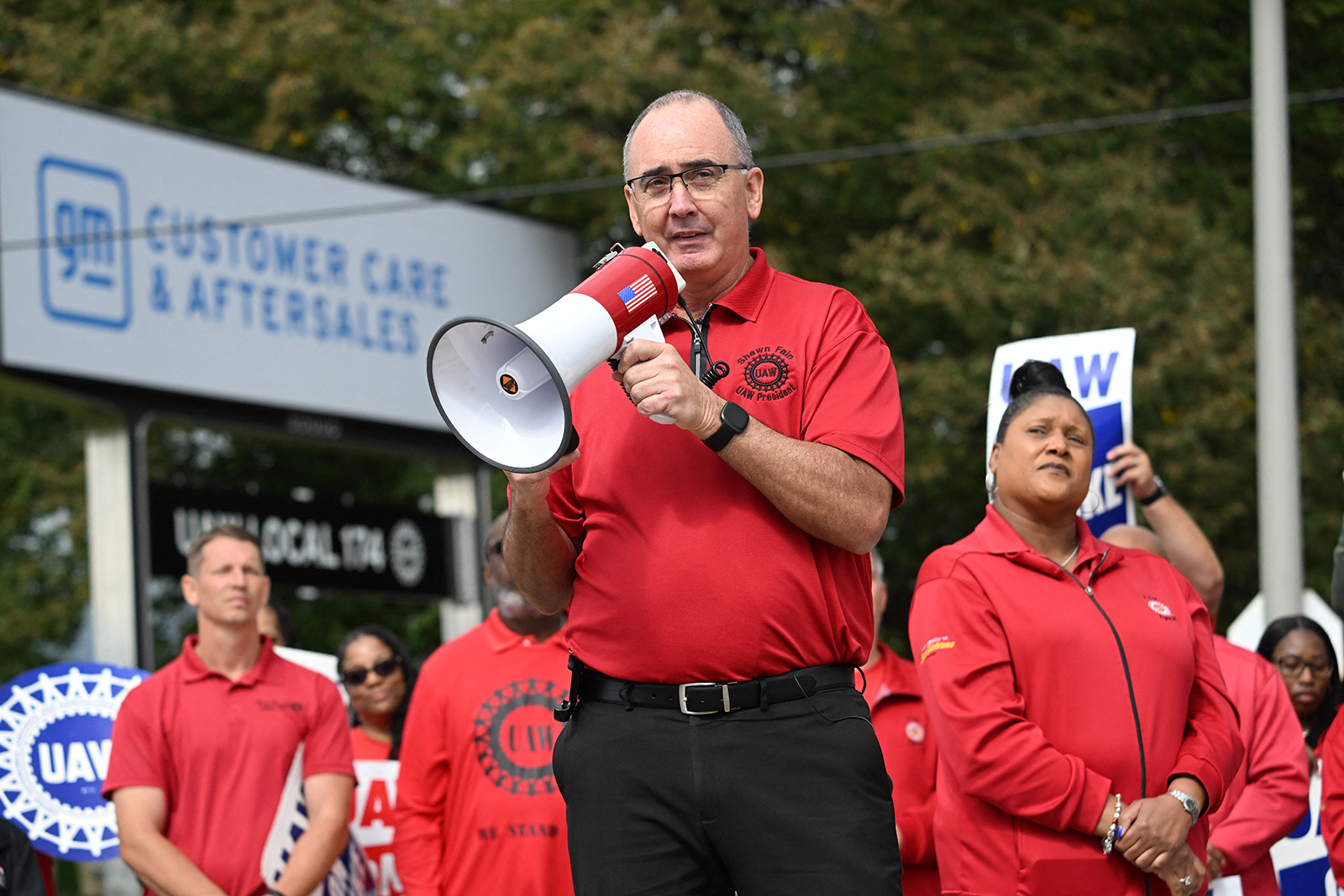 United Auto Workers (UAW) President, Shawn Fain addresses picketing UAW members at a General Motors Service Parts Operations plant in Belleville, Michigan, on September 26, 2023, as US President Joe Biden joined the workers. 