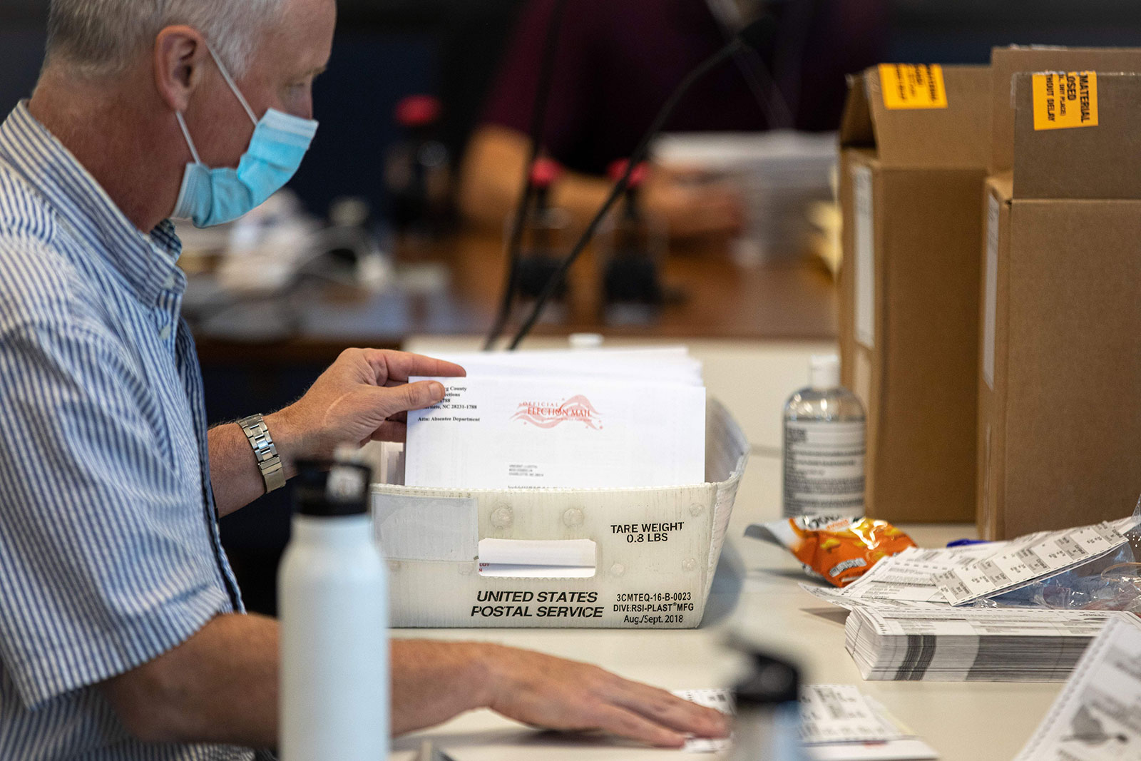 An election worker stuffs absentee ballot applications at the Mecklenburg County Boards of Elections office in Charlotte, North Carolina, on September 4.