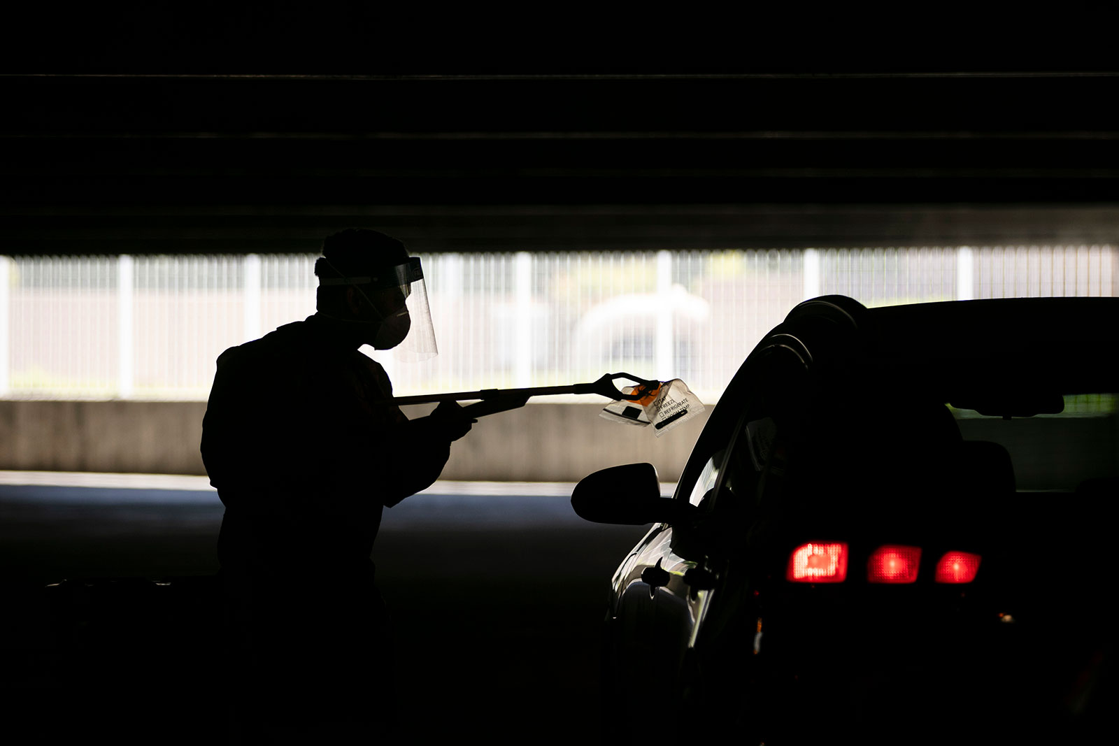 Physician assistant Calvin Tran collects a nasal swab sample at a coronavirus drive-thru testing site in Anaheim, California, on Thursday, July 16.