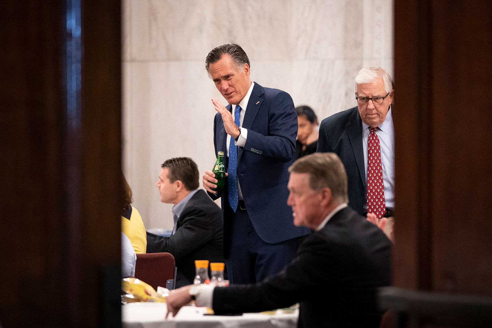 Sen. Mitt Romney attends a Senate GOP lunch meeting in Washington, DC, on Friday, March 20. Sen. Rand Paul, who tested positive for the coronavirus on Sunday, also attended the meeting.