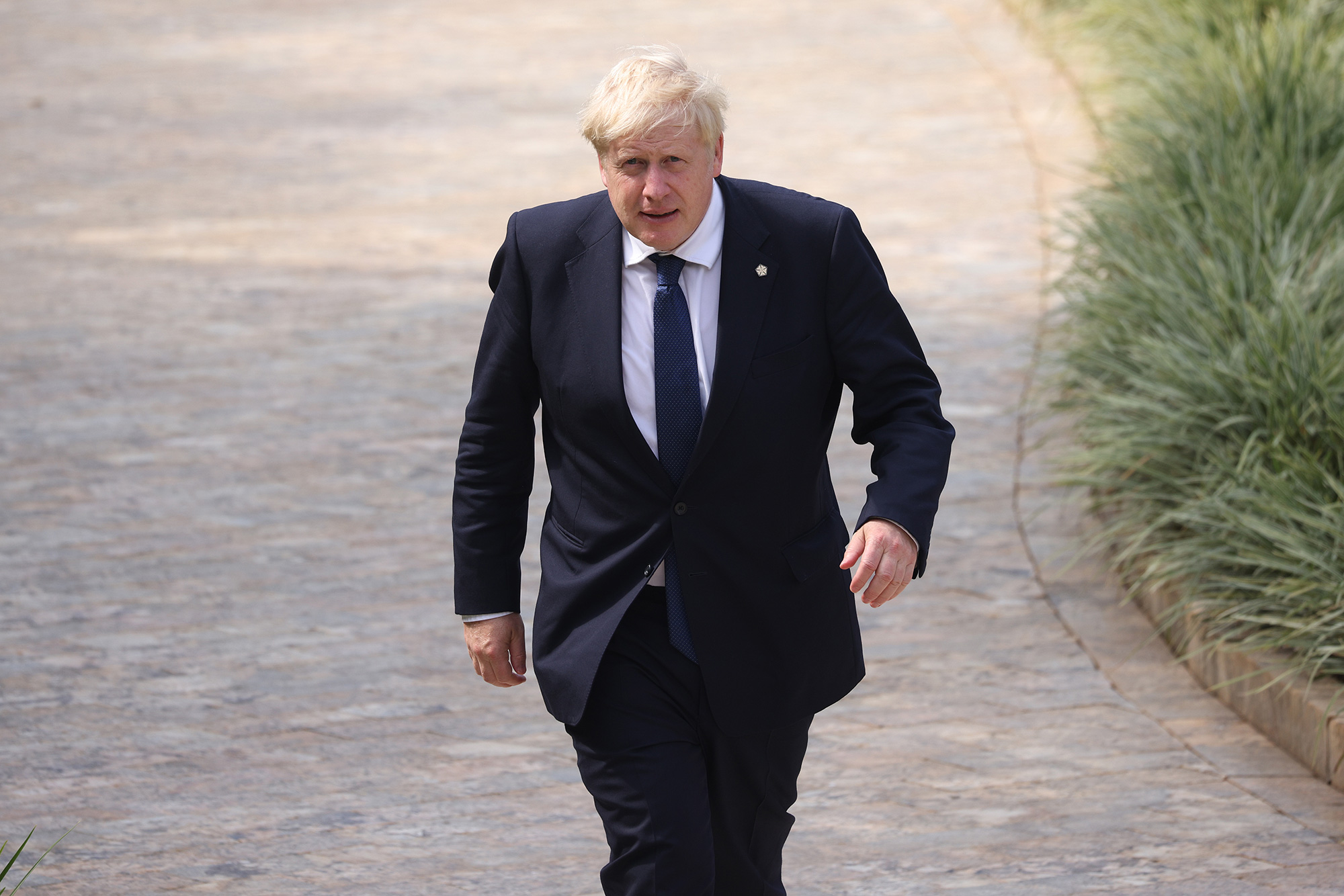 British Prime Minister Boris Johnson arrives for the leaders' retreat during the 2022 Commonwealth Heads of Government Meeting (CHOGM) in Kigali, Rwanda, on Saturday, June 25.