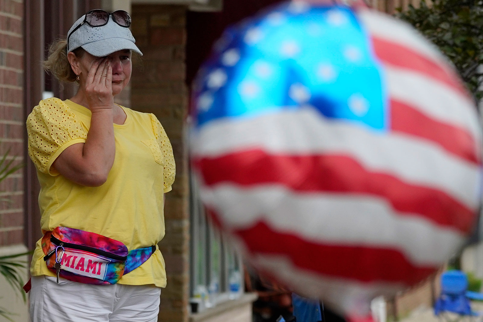 A woman wipes tears after a shooting at the Highland Park Fourth of July parade in Highland Park, Illinois, on July 4.