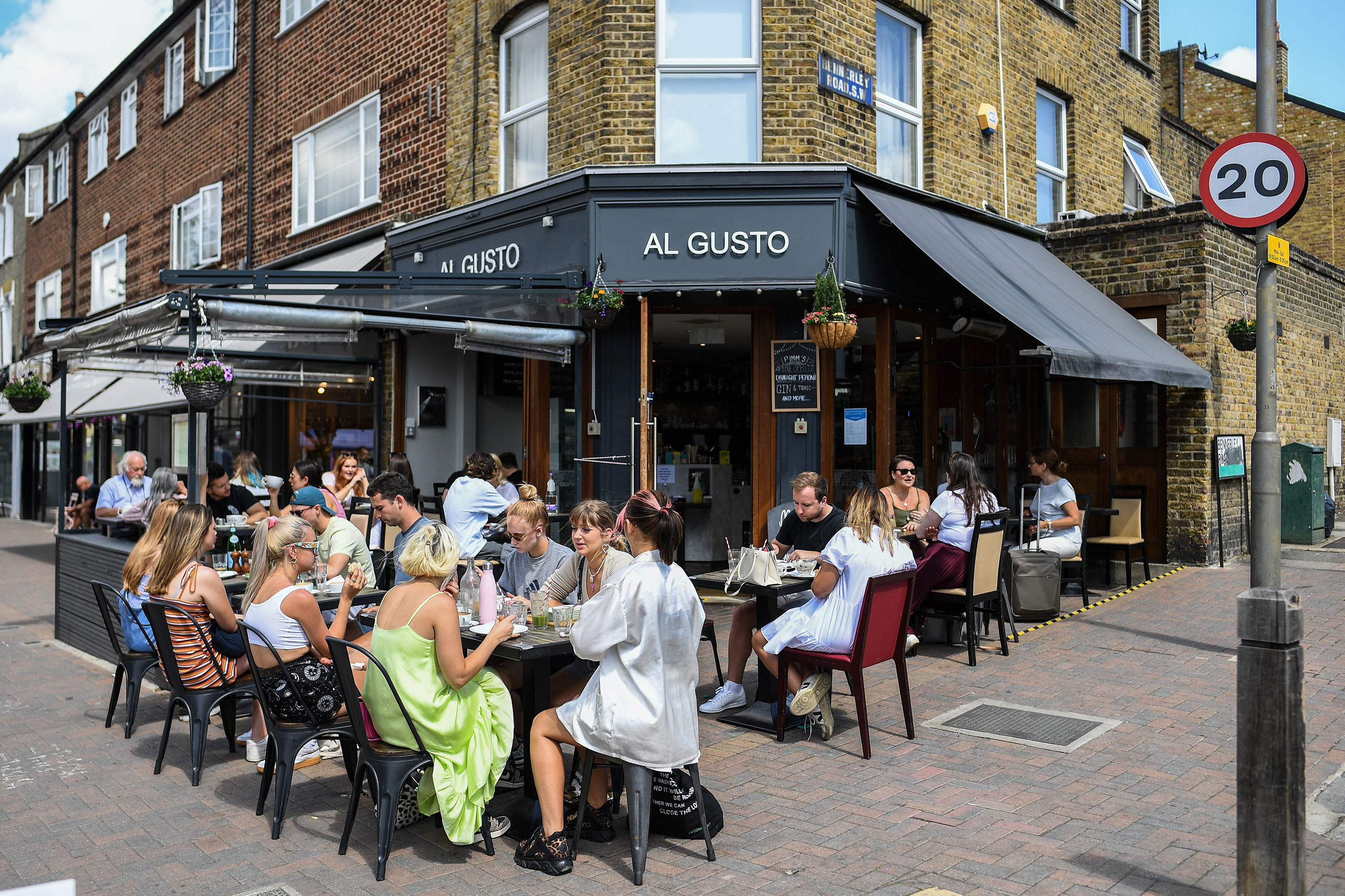People dine outdoors at a restaurant in Clapham, London, on August 2.