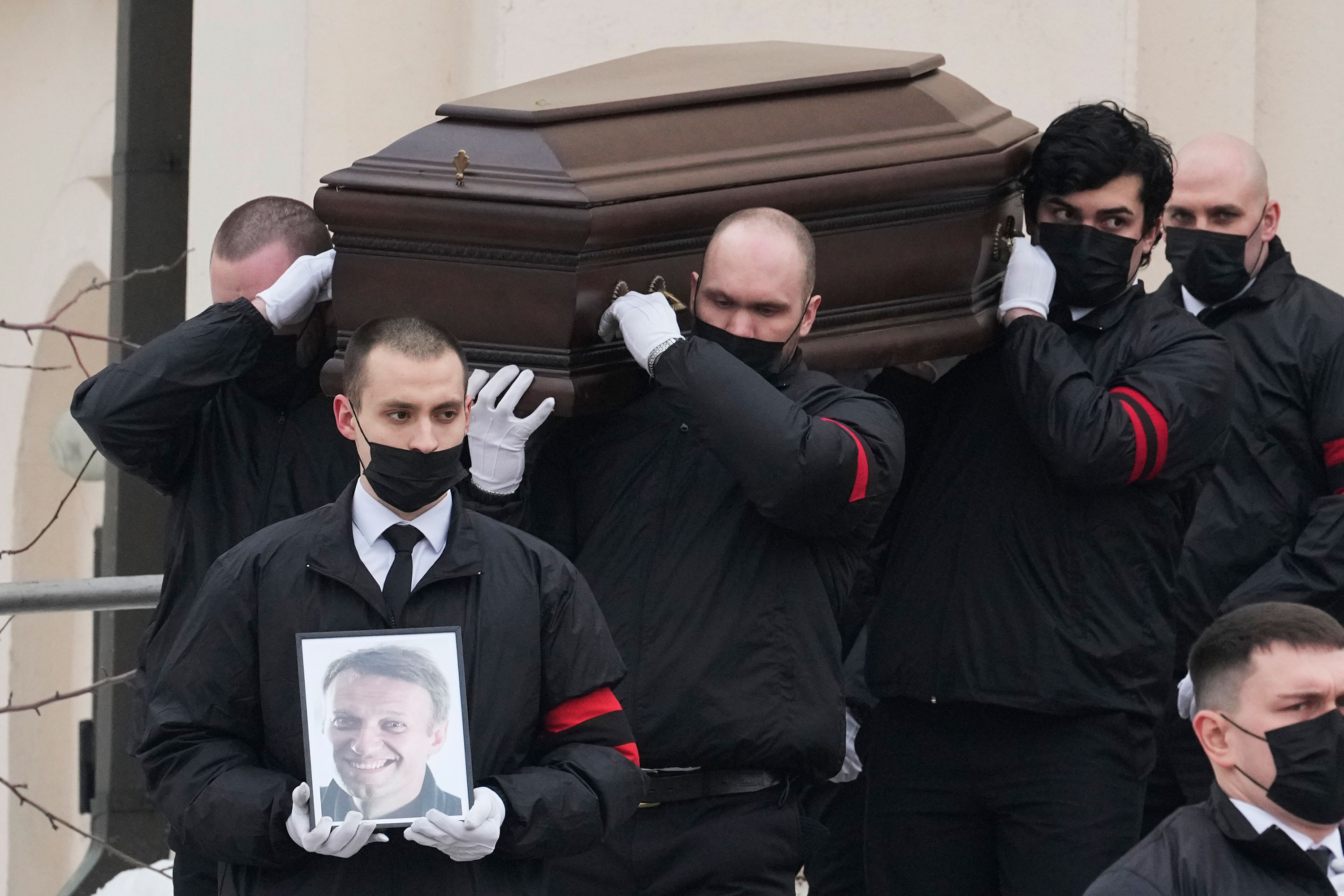 Navalny's coffin is carried out of the church after the funeral.