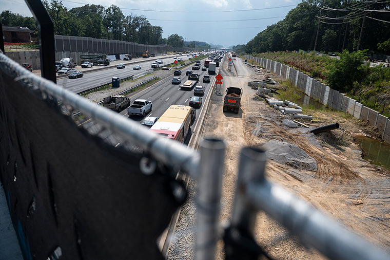 Cars drive past construction along Interstate Highway 66 in Manassas, Virginia, on August 10, 2021.