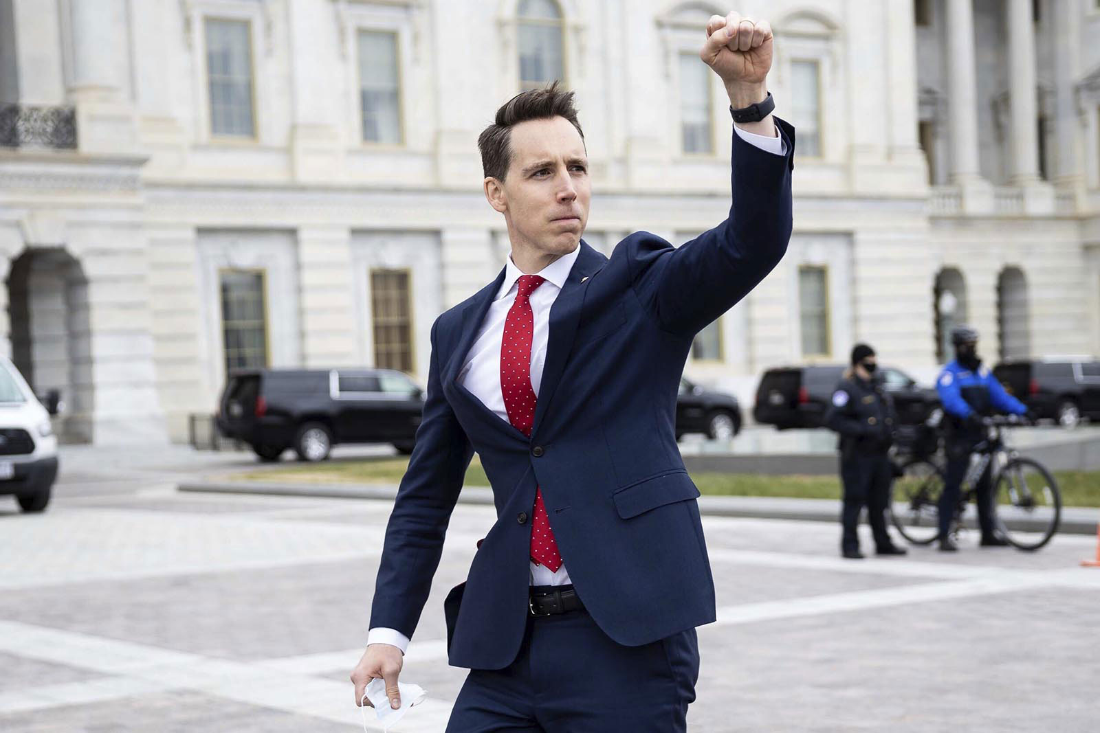 Missouri Sen. Josh Hawley gestures toward supporters of President Donald Trump gathered outside the Capitol on January 6.