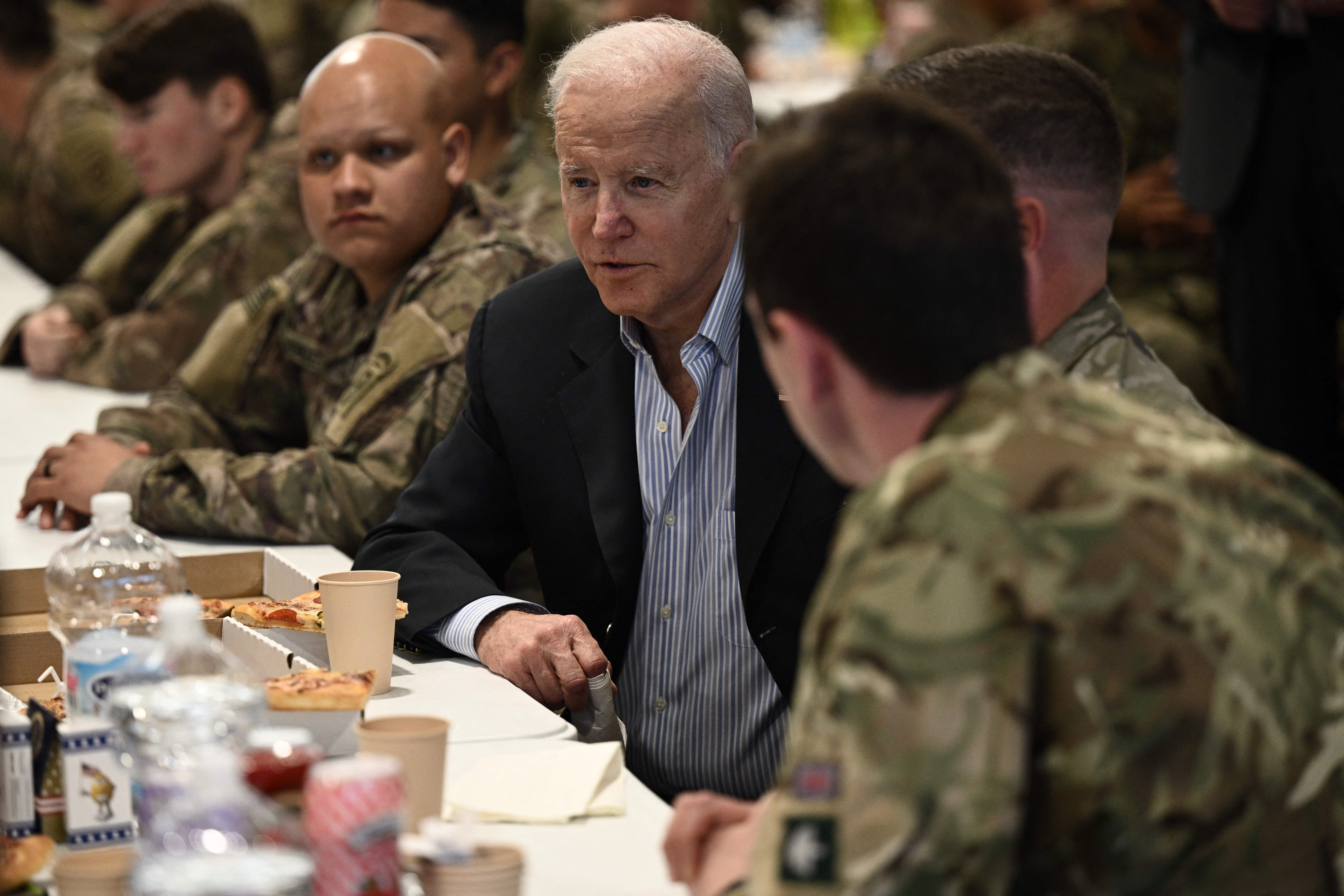 US President Joe Biden, center, talks to service members from the 82nd Airborne Division during his trip to Poland on March 25.