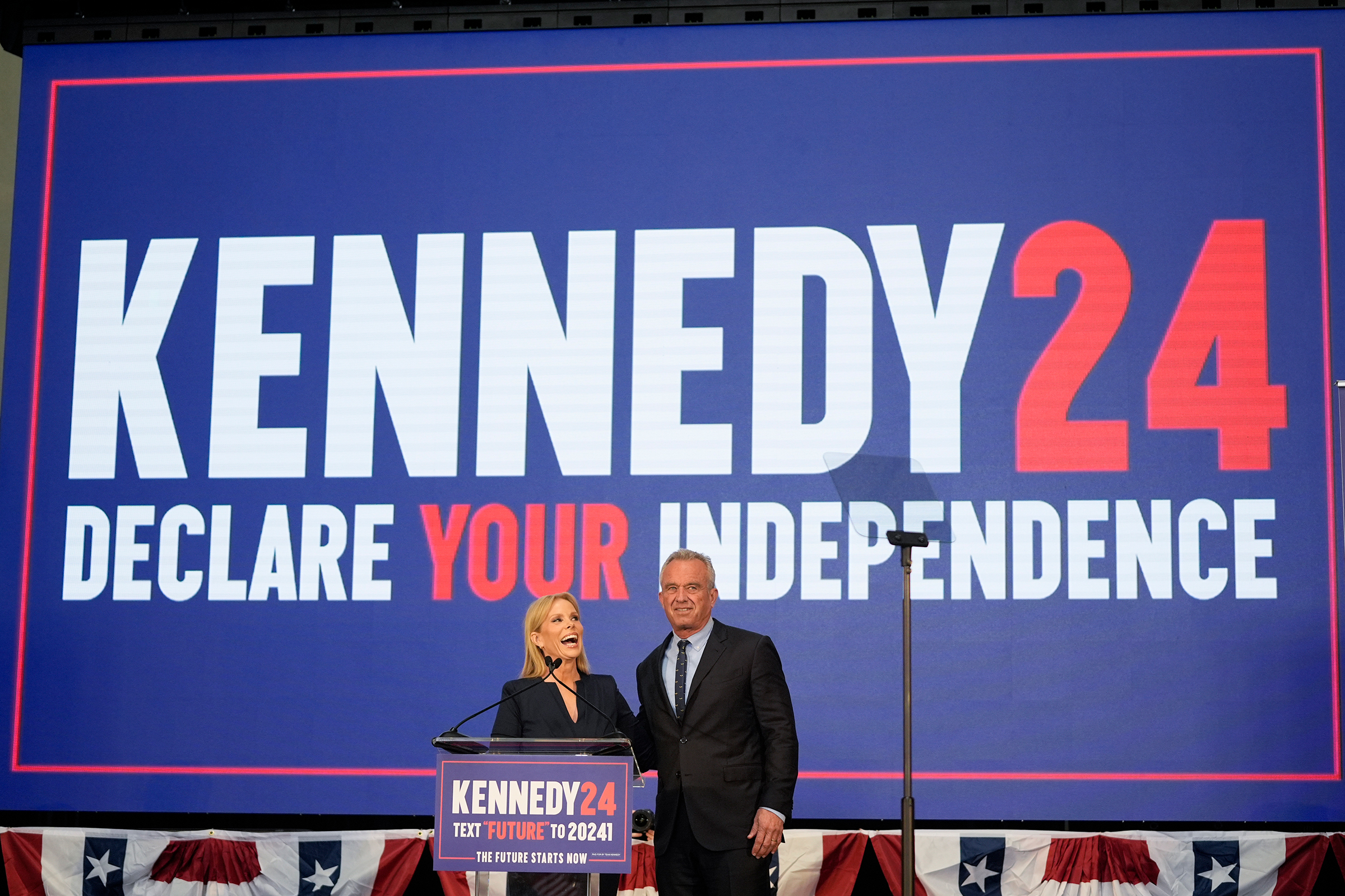 Presidential candidate Robert F. Kennedy Jr. right, is joined on the stage by his wife Cheryl Hines during a campaign event on Tuesday in Oakland, California.