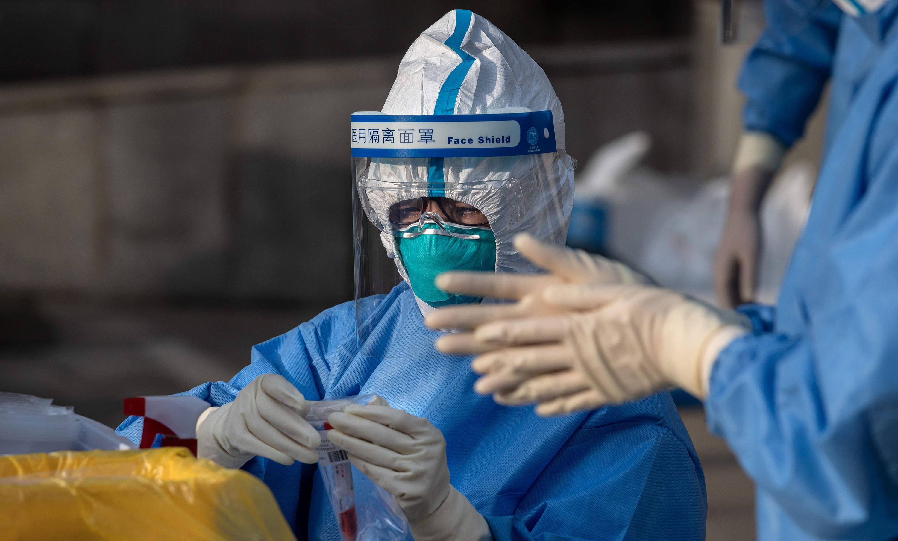 A medical worker collects coronavirus test swabs during the National People's Congress in Beijing, China, on May 24.