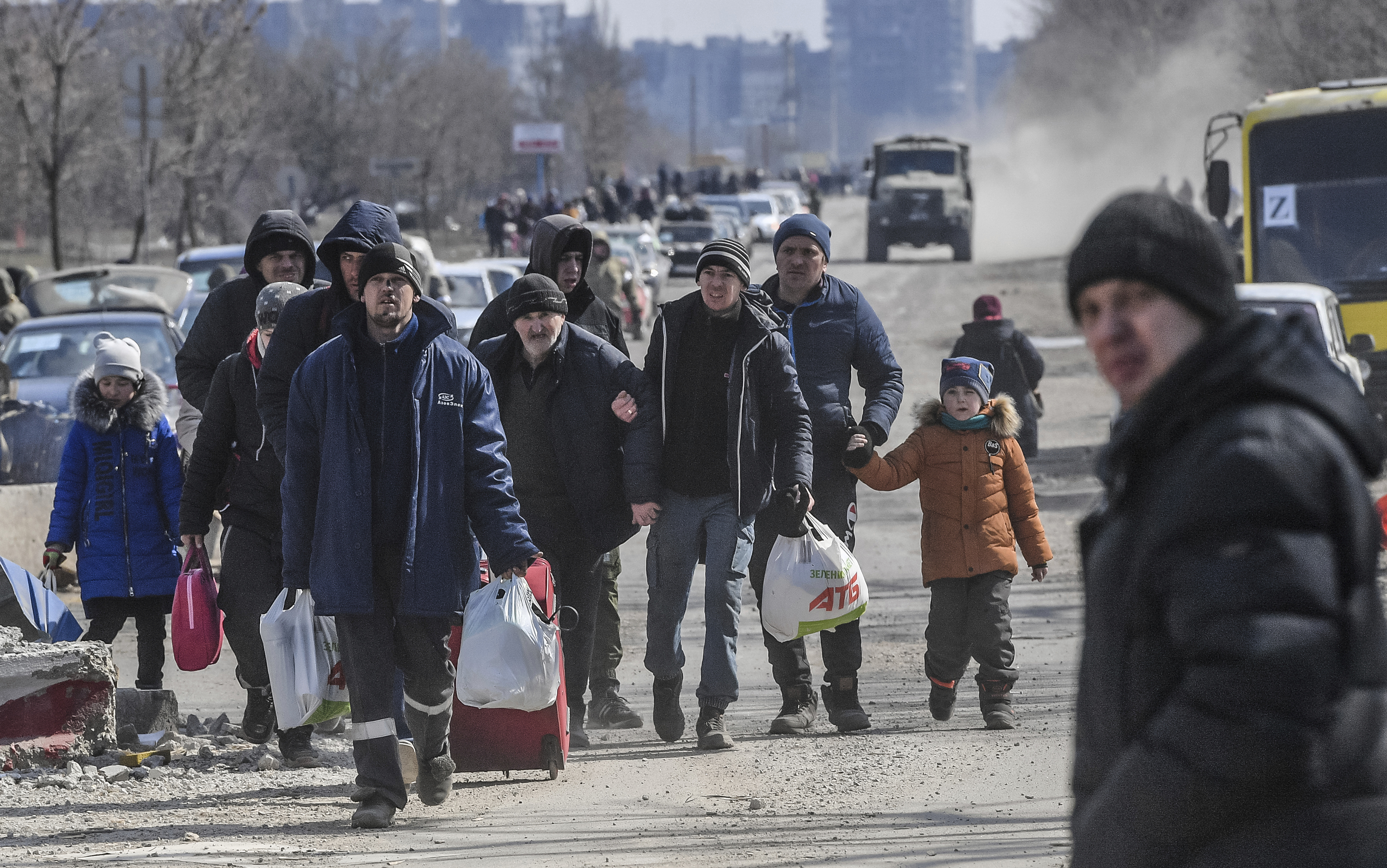 Residents leave the city of Mariupol on March 18. The city has been a site of intense fighting in recent weeks.