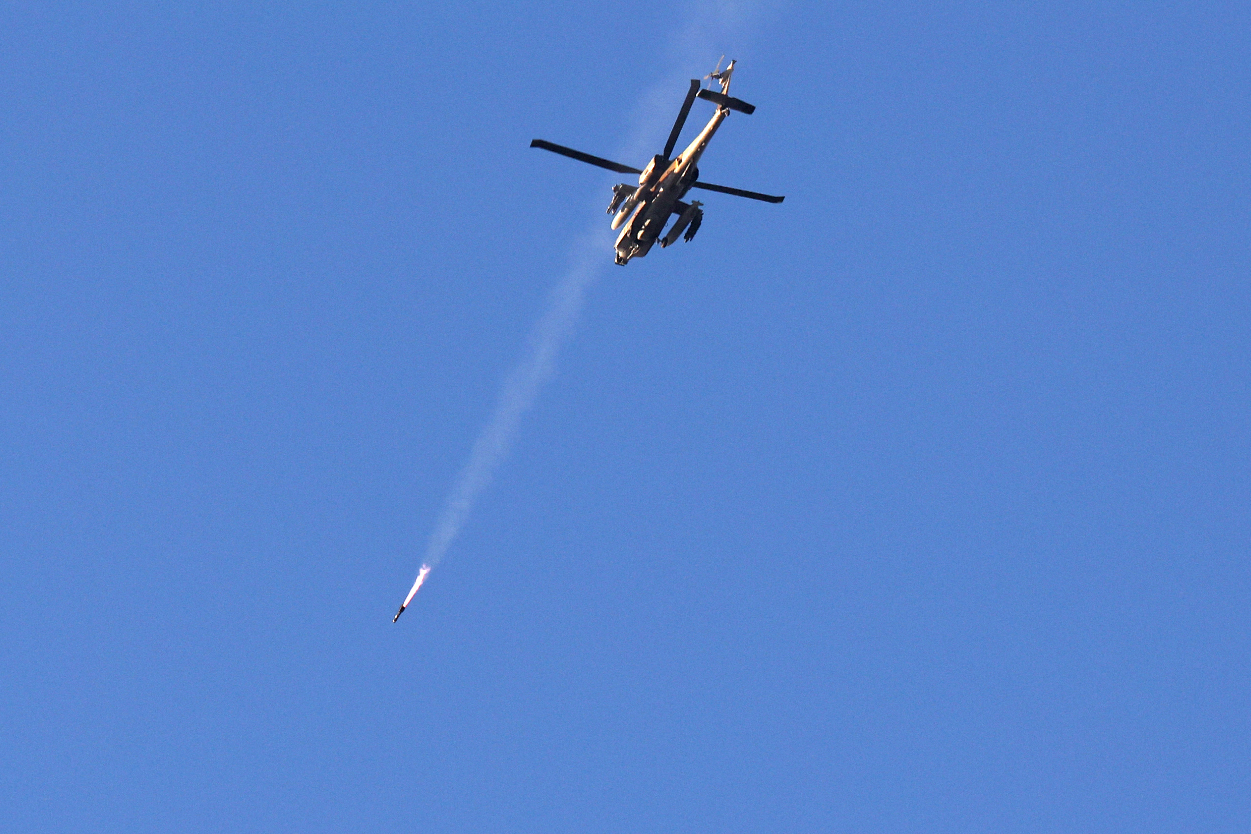 An Israeli Air Force helicopter fires a missile while flying over the border with Gaza, near southern Israel, on Saturday, December 2.