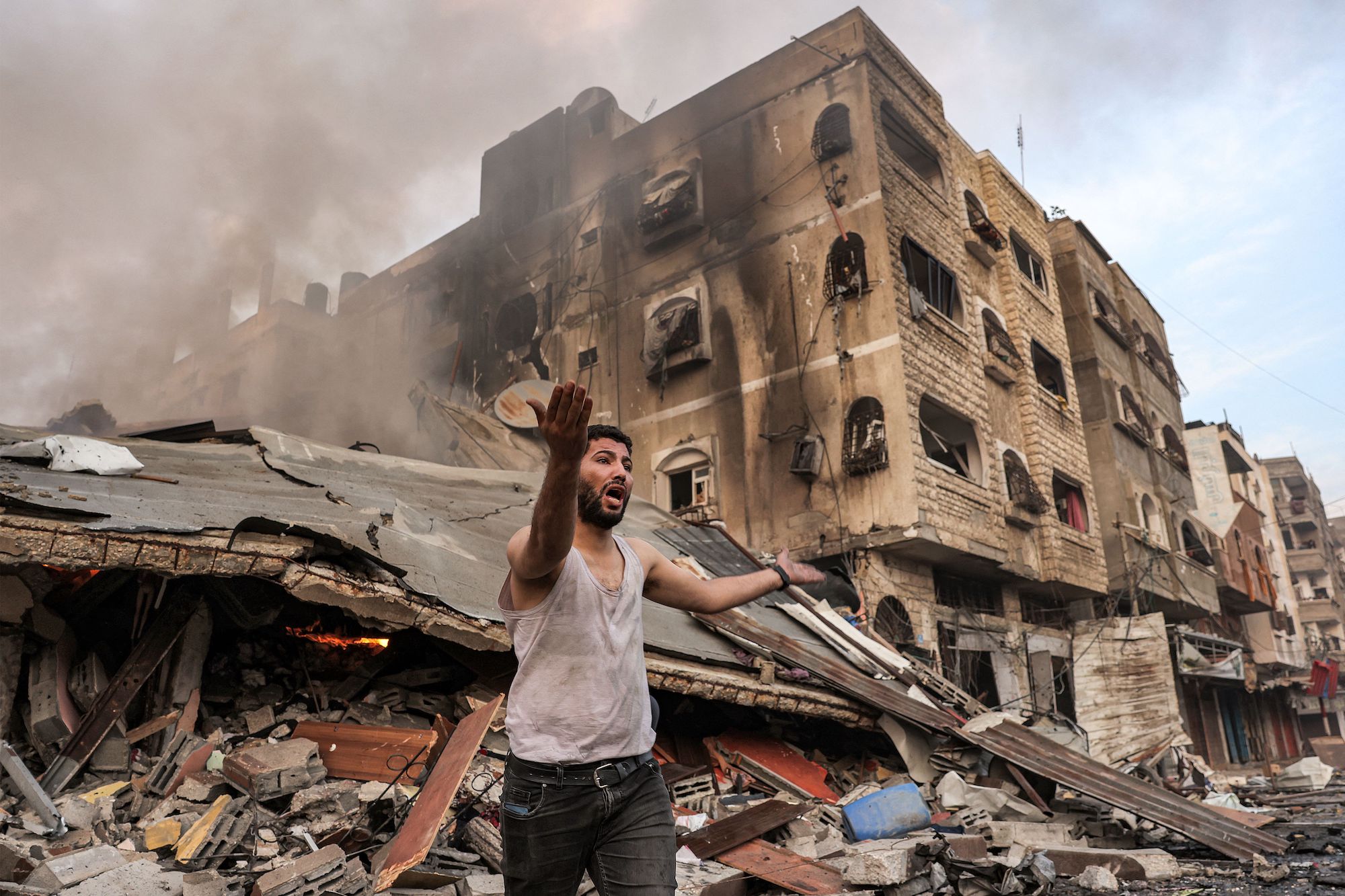 A man reacts outside a collapsed building following an Israeli bombardment in Gaza City on Wednesday.