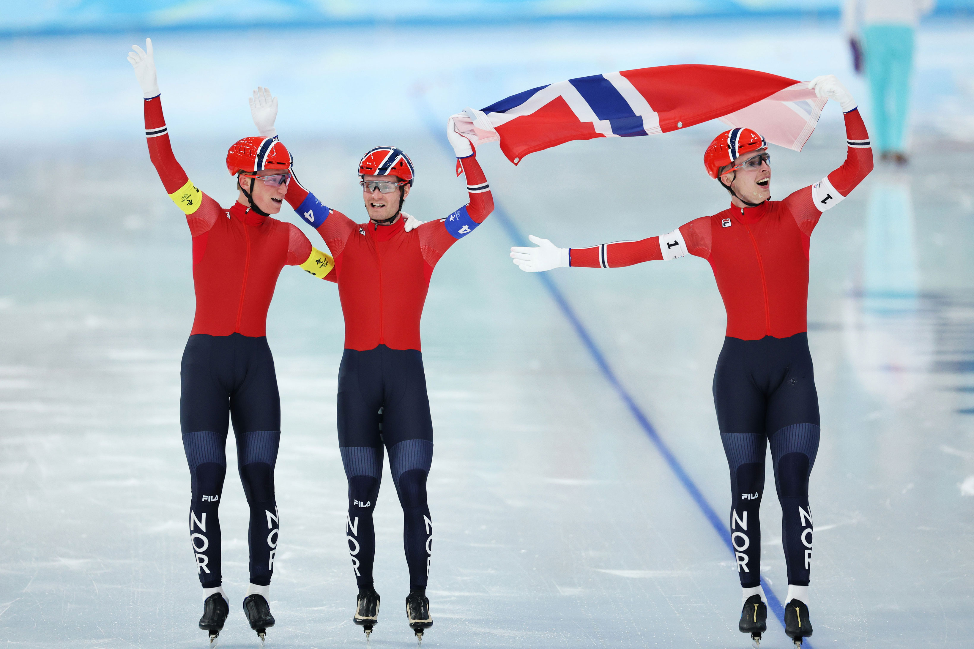 Peder Kongshaug, Sverre Lunde Pedersen and Hallgeir Engebråten of Norway celebrate winning gold medal during the men's team pursuit final on Feb. 15