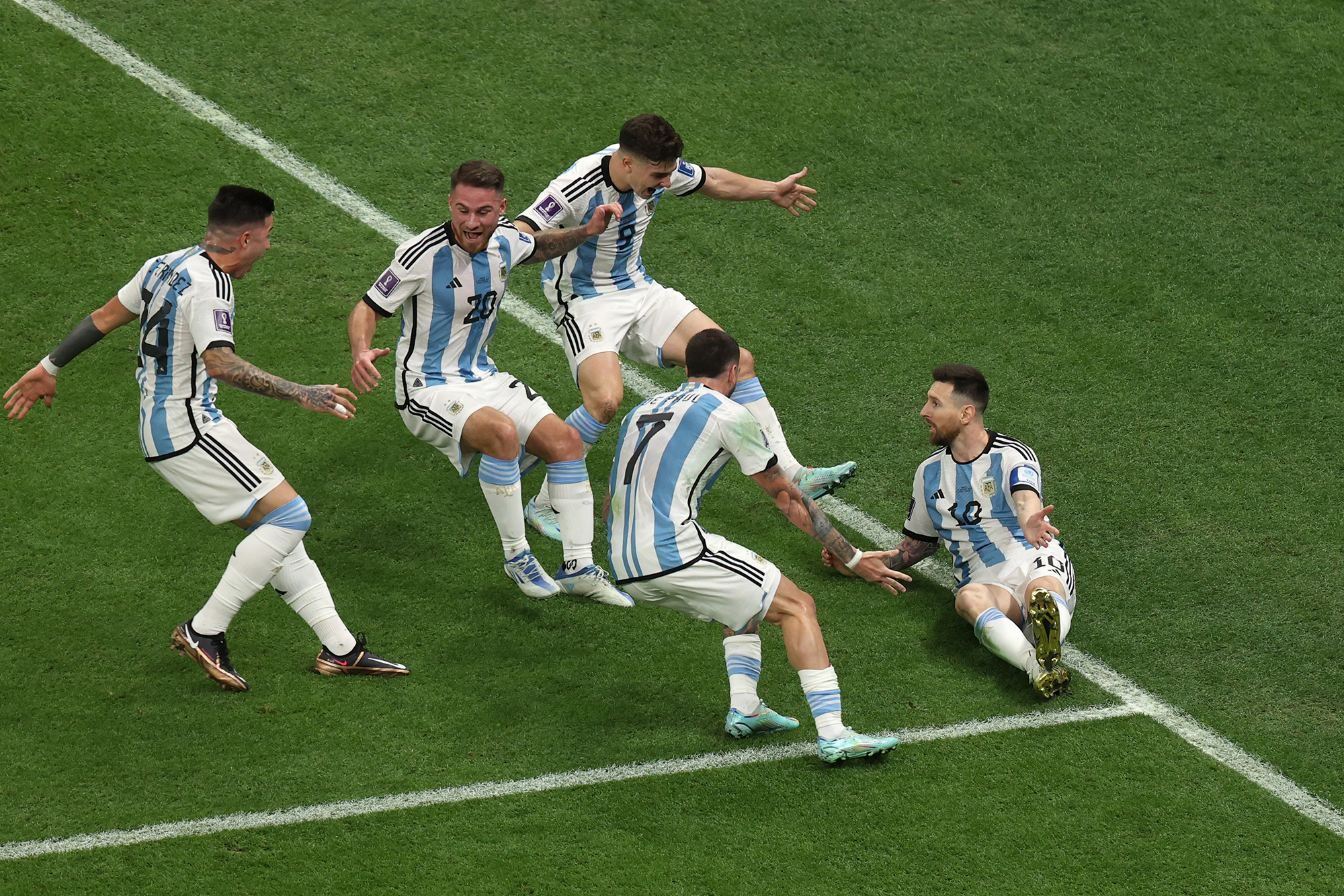 Argentina players celebrate Messi's opening goal.