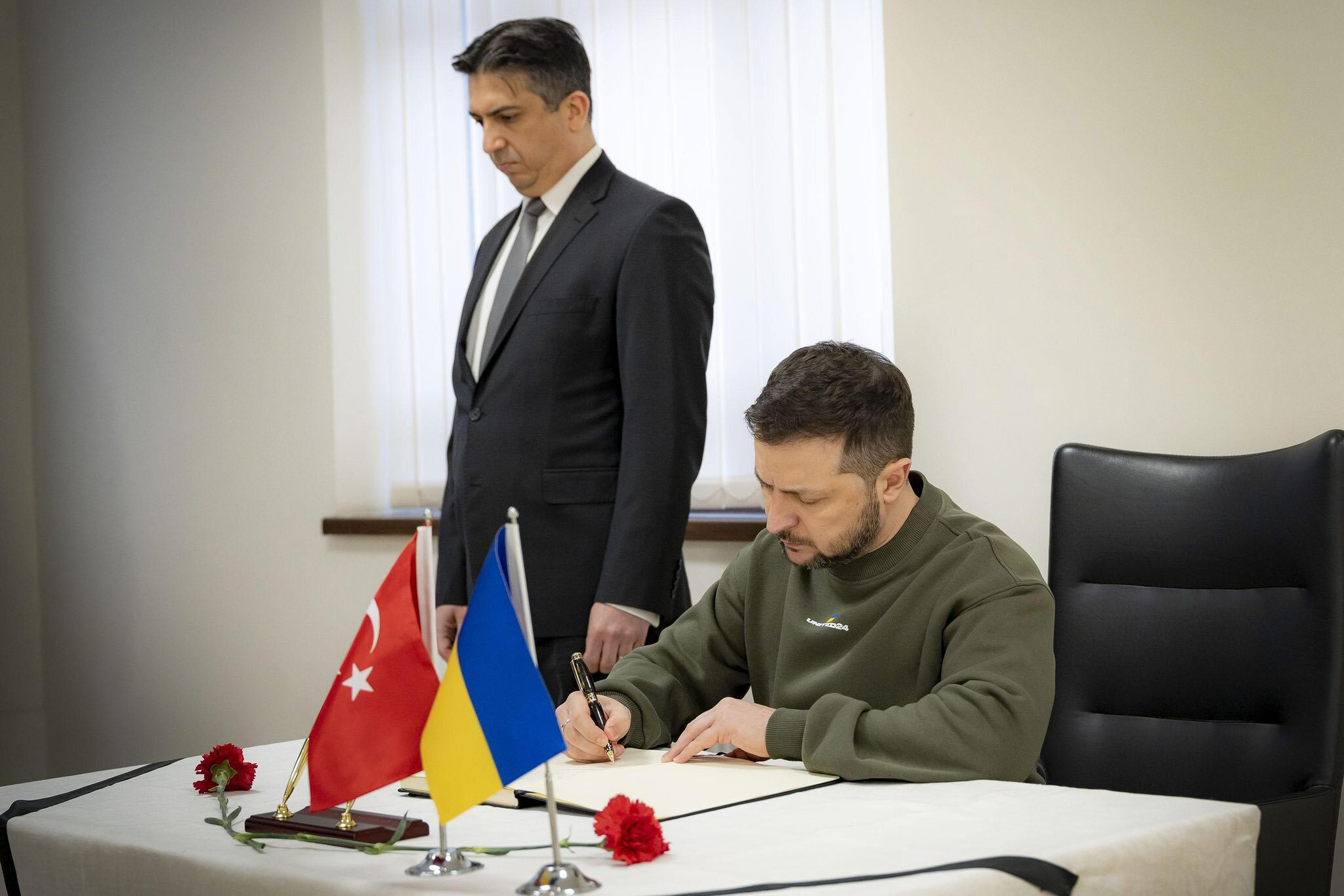 Ukrainian President Volodymyr Zelensky signs a condolence book at the Turkish Embassy in Kyiv, Ukraine, on February 11. 