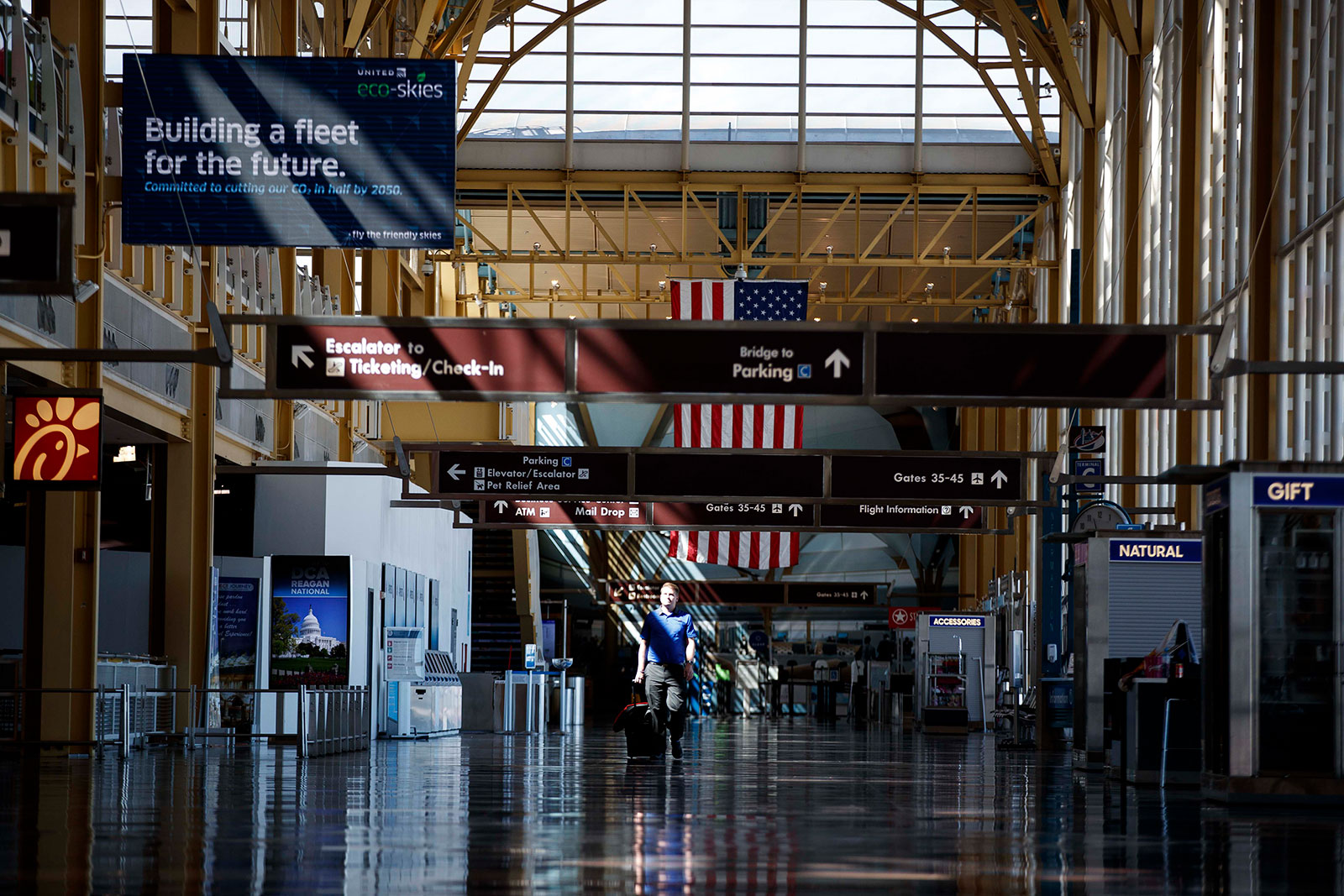 A person walks through a nearly empty terminal at Ronald Reagan Washington National Airport on March 30.