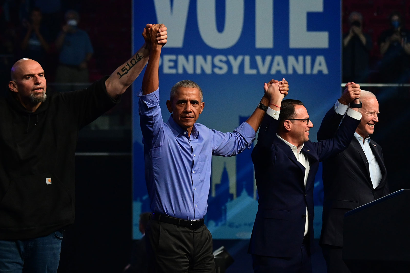 John Fetterman, former President Barack Obama, Josh Shapiro and President Joe Biden stand together at a rally Saturday night. 