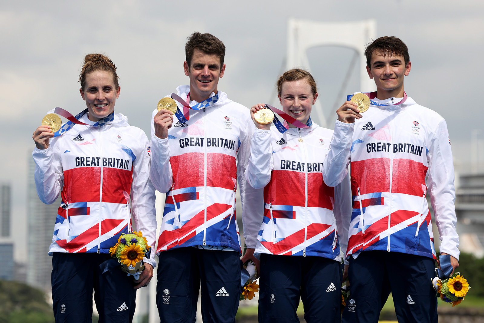 Jessica Learmonth, Jonny Brownlee, Georgia Taylor-Brown and Alex Yee of Britain pose with their gold medals following the mixed relay triathlon on Saturday, July 31.