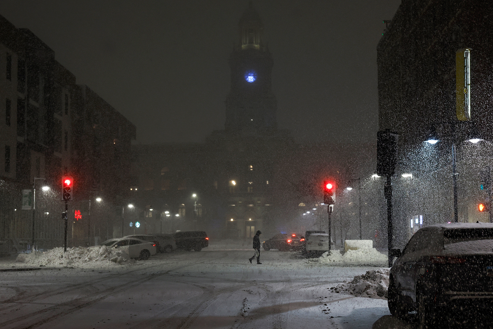 A pedestrian walks in the streets of downtown Des Moines, Iowa, during a snow squall on Wednesday.