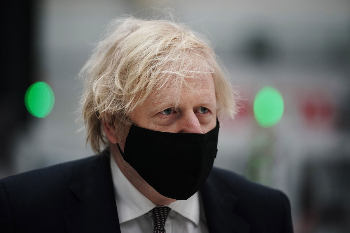 UK prime minister Boris Johnson wears a face mask during a visit to BAE Systems at Warton Aerodrome on March 22 in Preston, England.