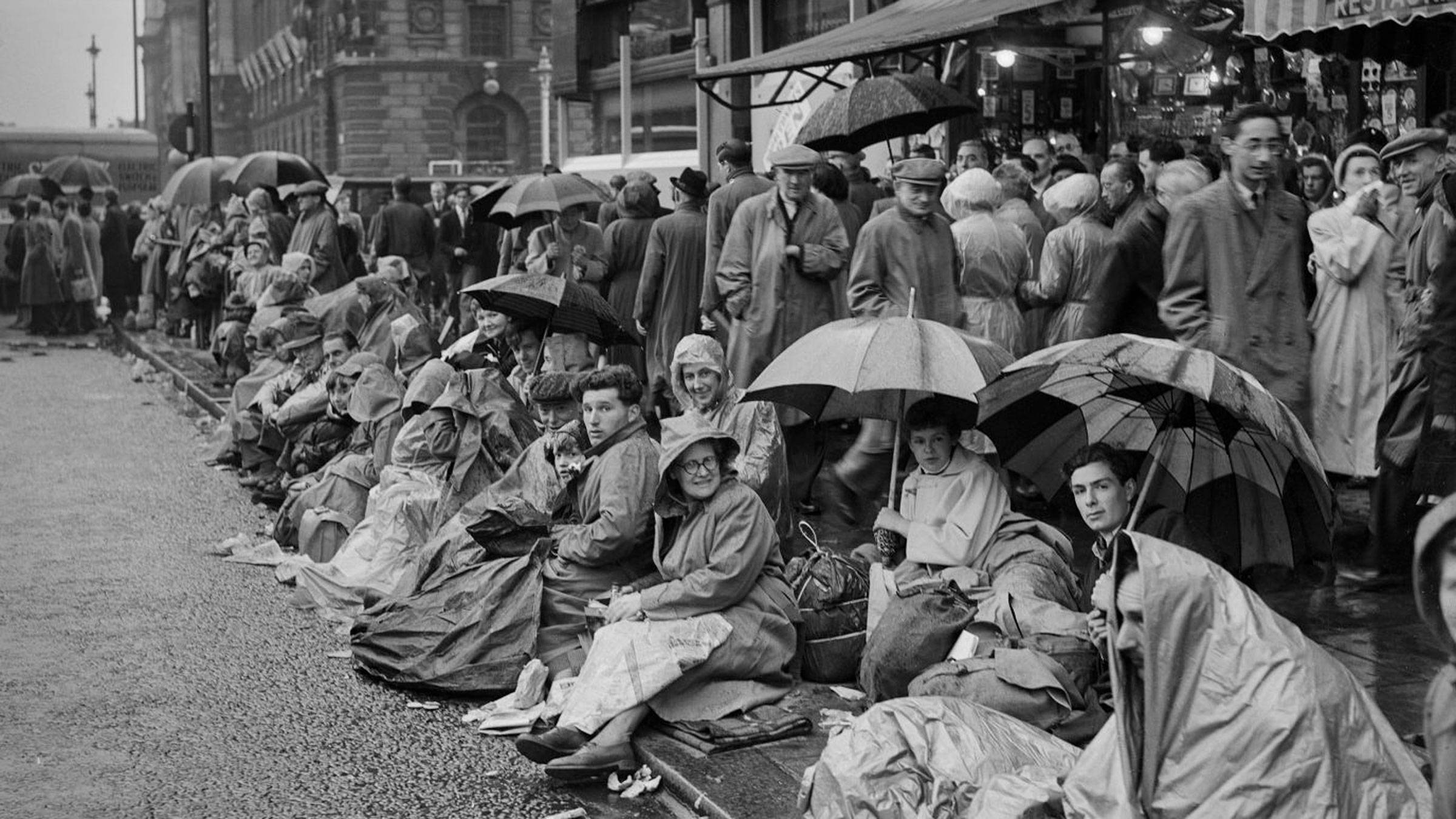 Well-wishers line the procession route in London. People slept along the route on the night before the coronation.
