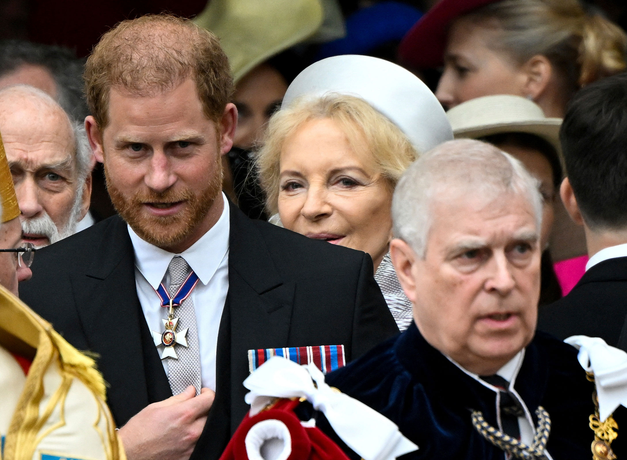 Britain's Prince Harry, Duke of Sussex, and Prince Andrew leave Westminster Abbey following the coronation ceremony of Britain's King Charles and Queen Camilla.