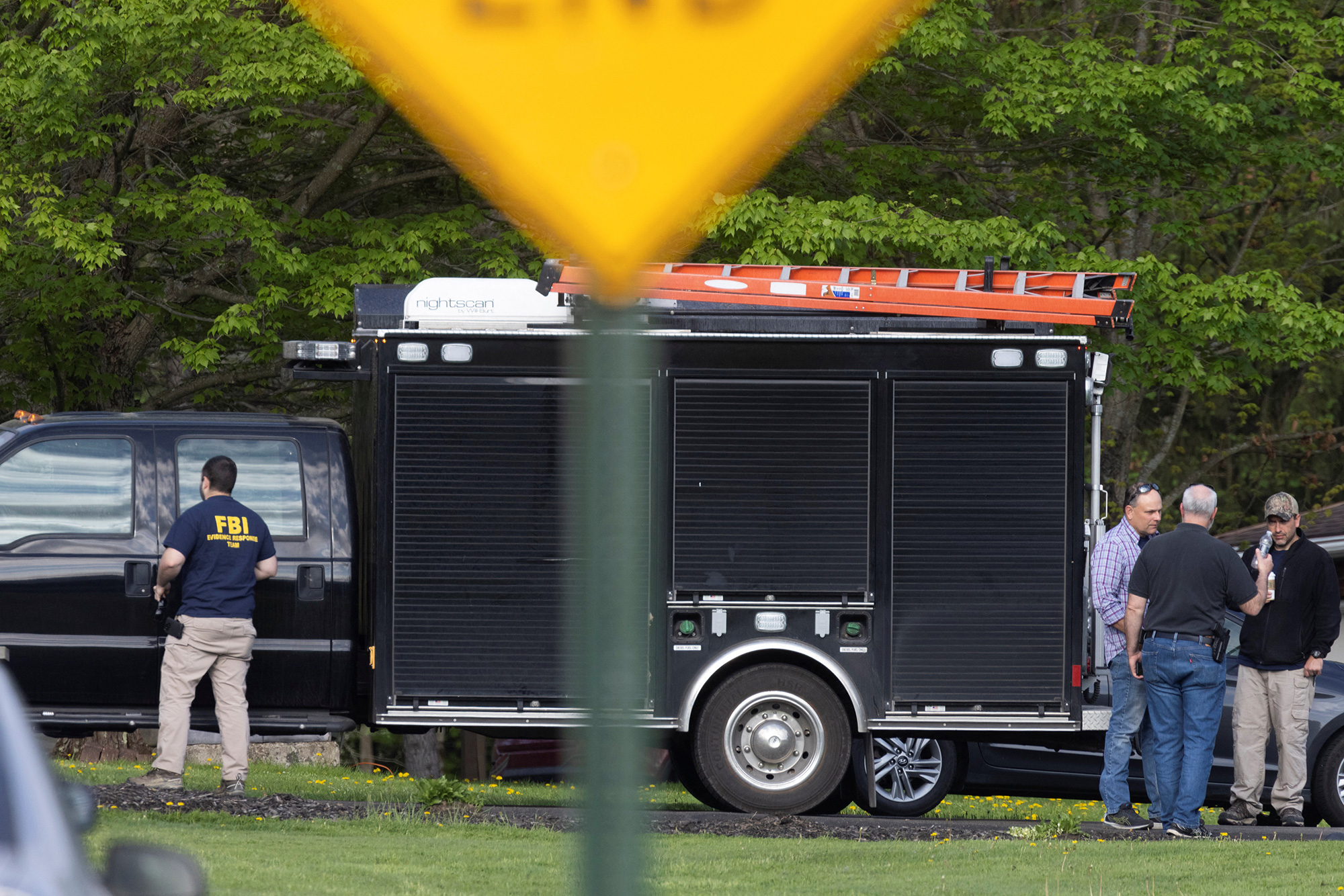 Law enforcement personnel are seen at the home of Buffalo supermarket shooting suspect Payton Gendron in Conklin, New York on May 15.