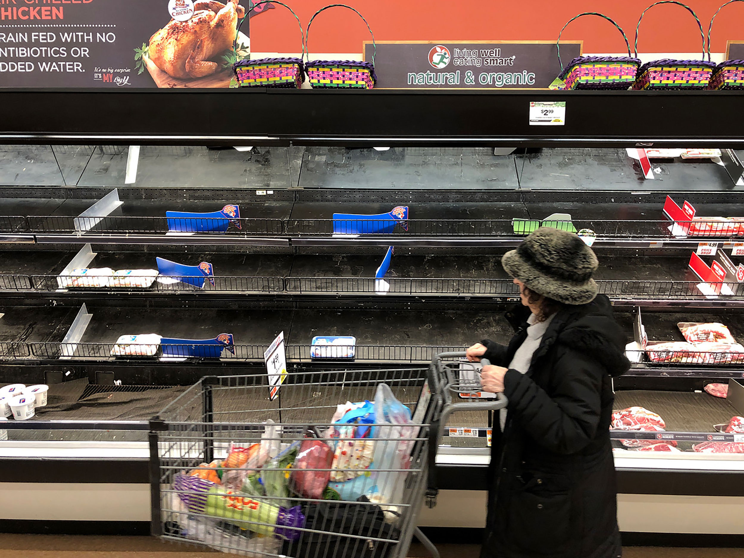 A person walks past empty shelves at a supermarket in Saugus, Massachusetts, on March 13.