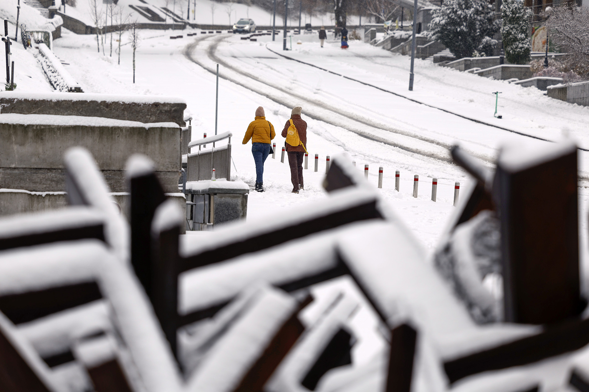 People walk along a snow-covered street on November 19, in Kyiv, Ukraine.