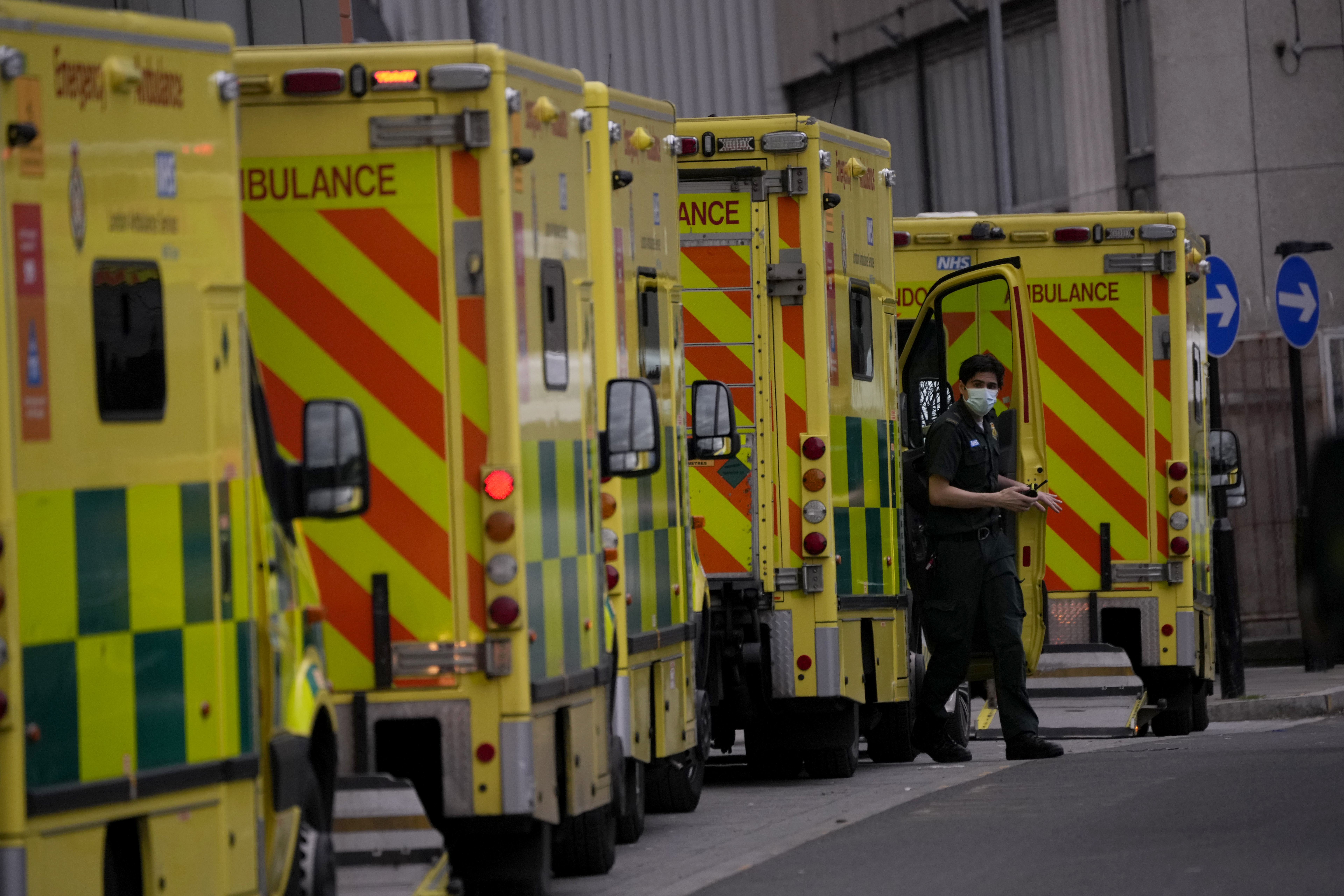 A paramedic gets out of an ambulance outside the Royal London Hospital in the Whitechapel area of east London, Thursday, January 6, 2022. A string of National Health Service local organizations have declared "critical incidents" in recent days amid staff shortages. 