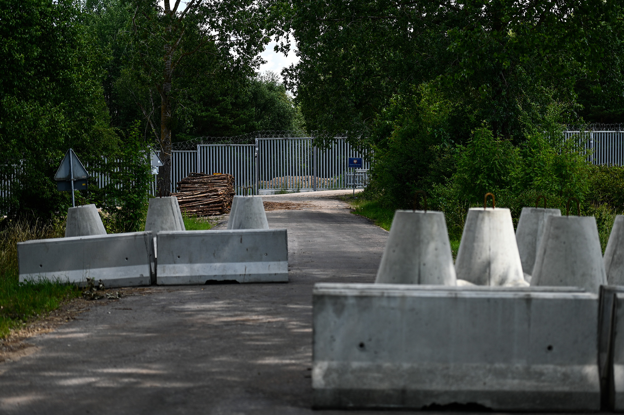Anti-tank obstacles are pictured by the metal wall constructed at the Polish Belarussian border on July 9, in Krynki, Poland. 