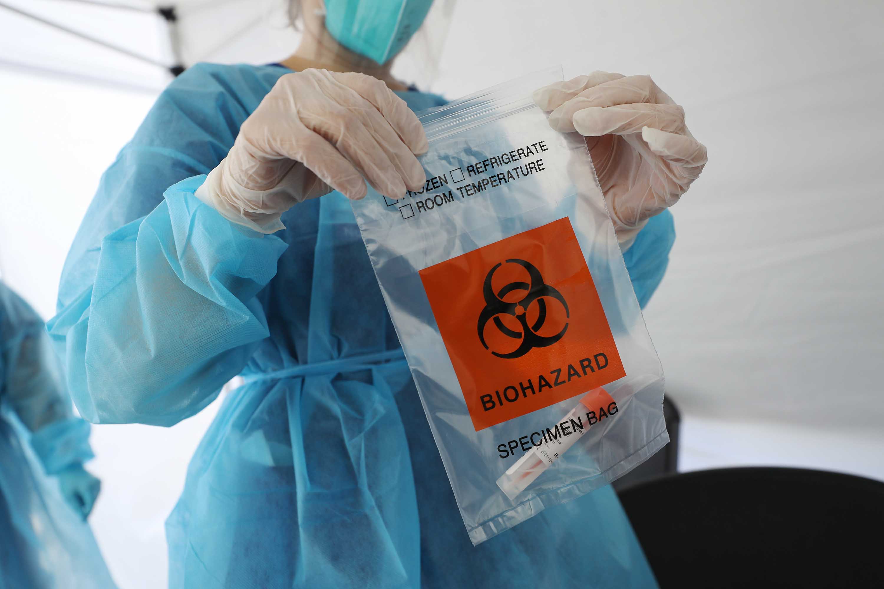A nurse seals a specimen bag containing a Covid-19 test swab at a mobile clinic set up outside Walker Temple AME Church in Los Angeles, California, on July 15.